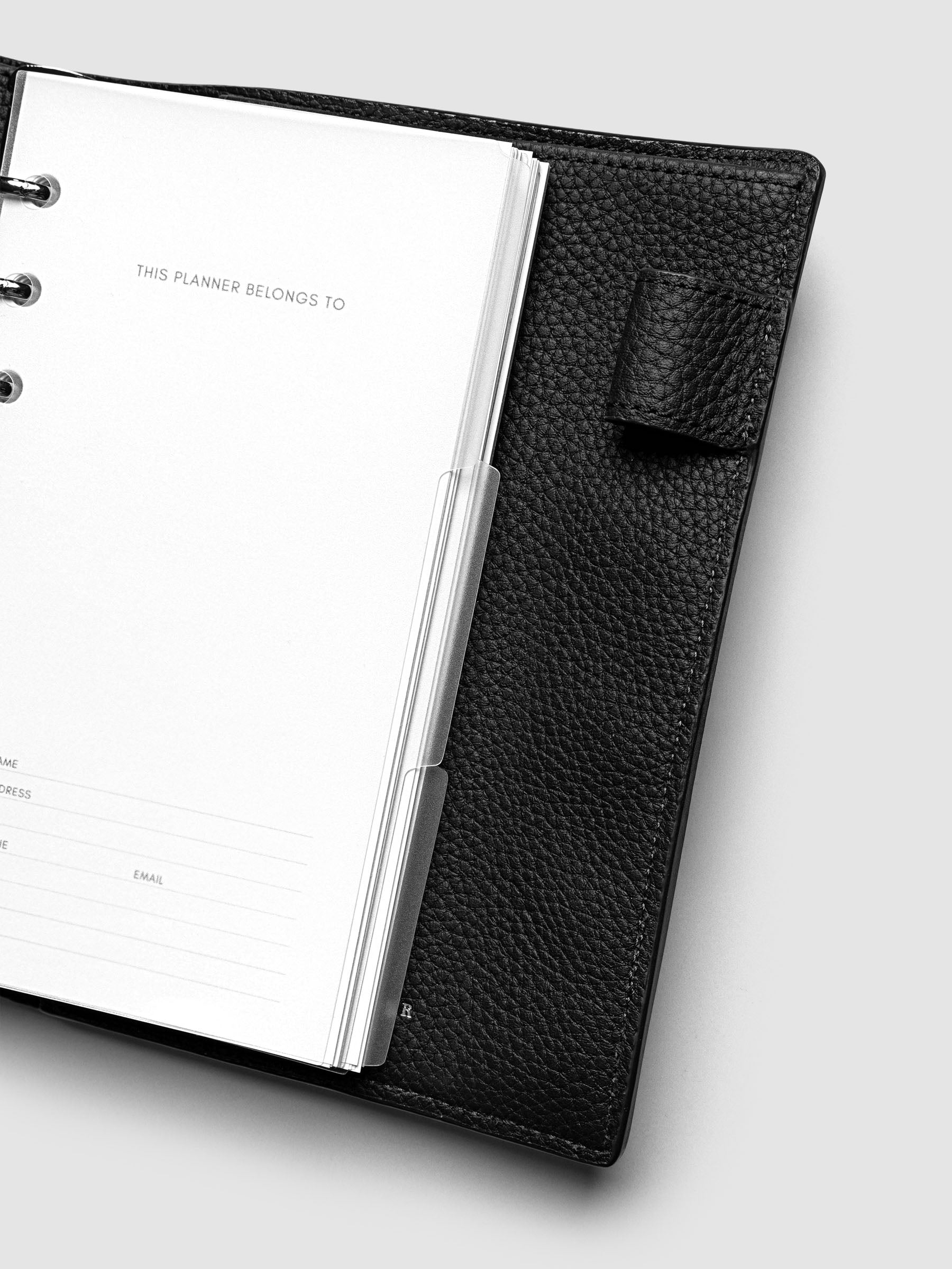 Blank, transparent side tab divider set shown in a Personal planner.