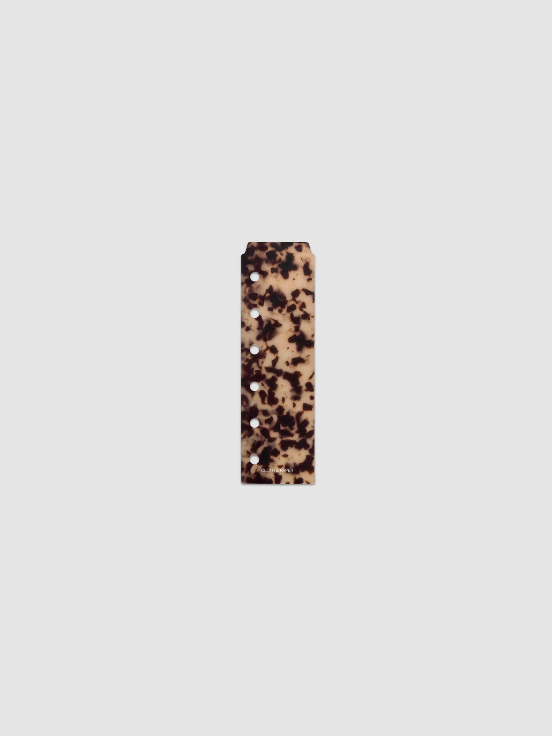 One narrow page marker in tortoiseshell pattern, shown in size Pocket.