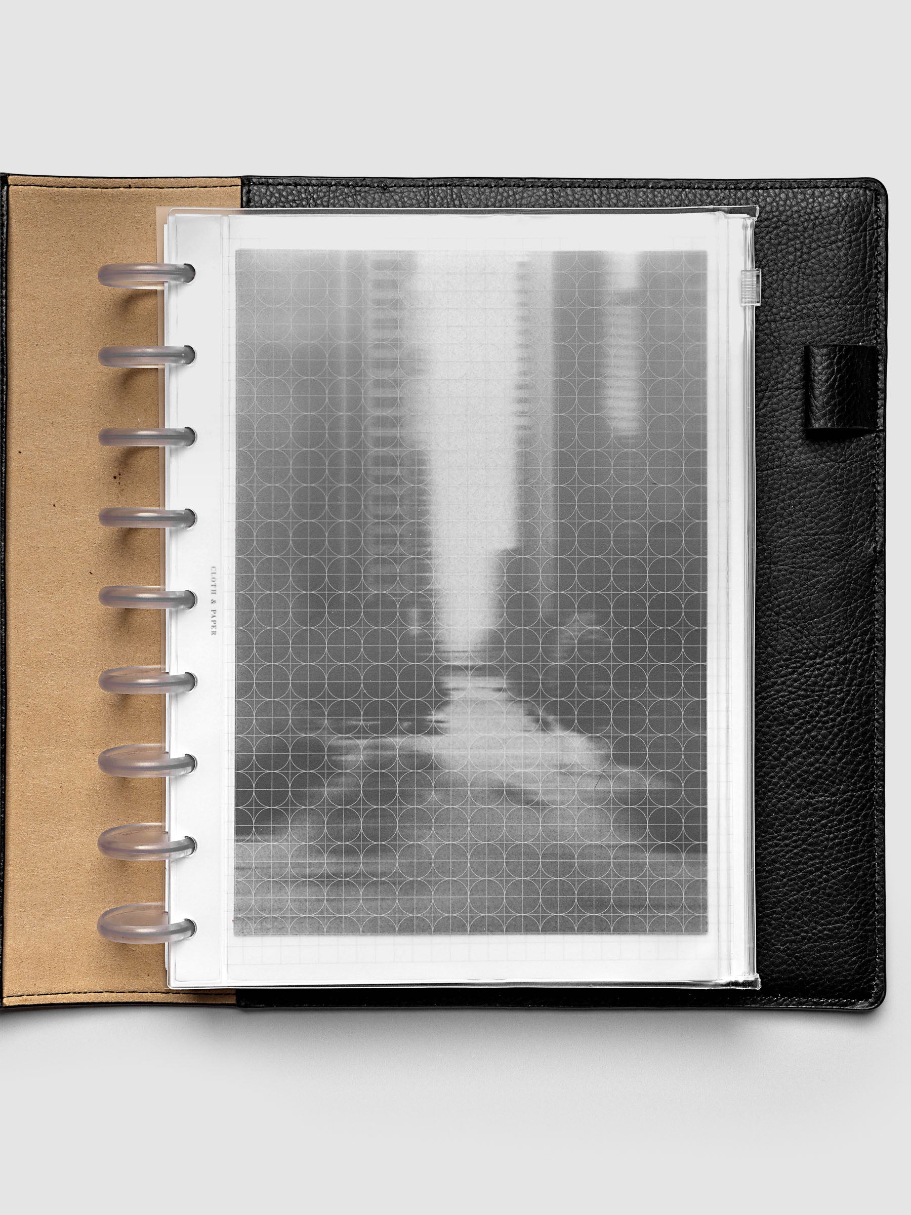 Side zipper transparent storage pouch for planners with decorative inner graph and photograph layers shown in a HP Classic planner folio cover.