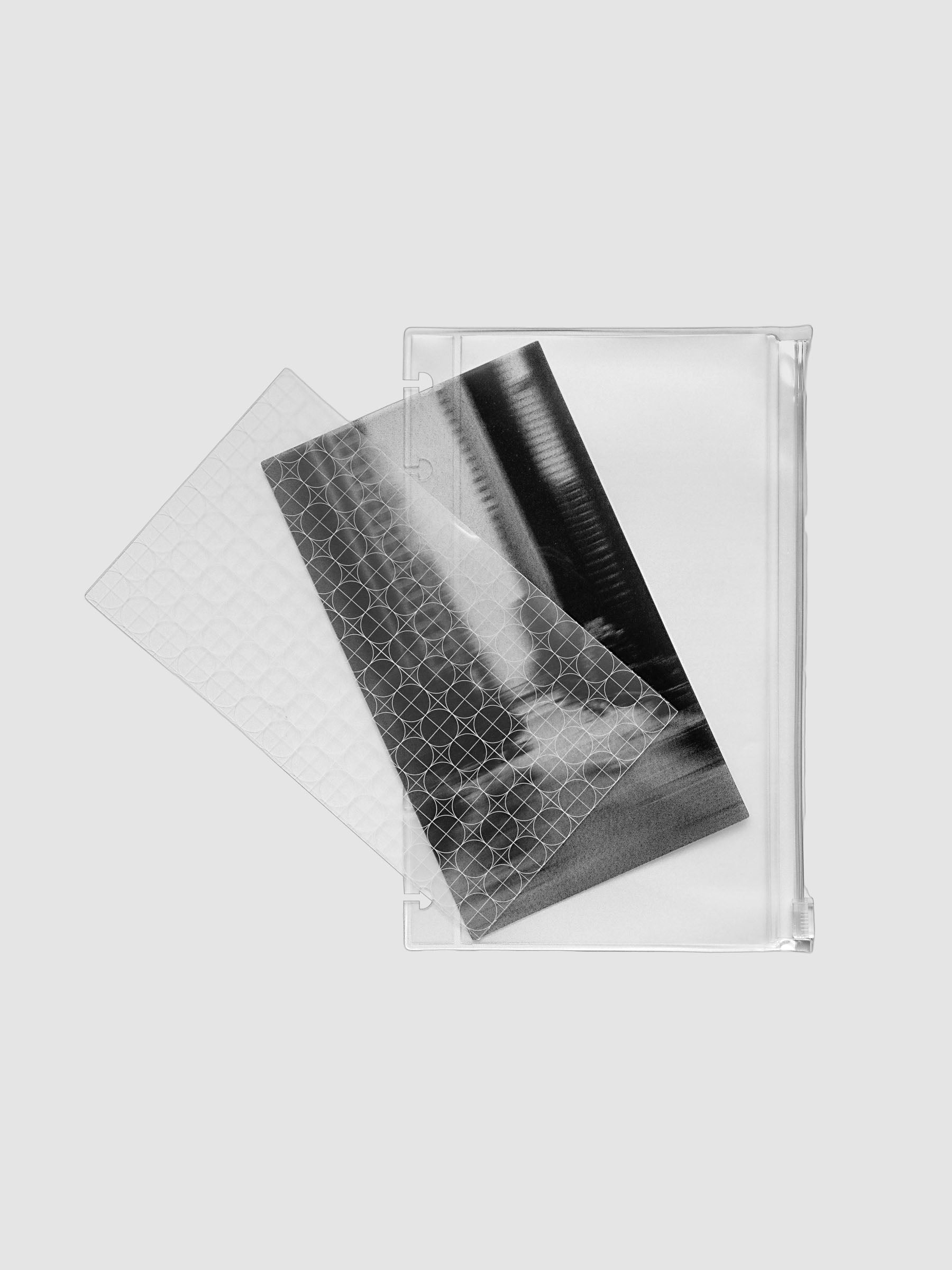 One transparent graph overlay, one black and clear abstract photo overlay, and one clear pre-punched zippered pouch for planners. Shown in size HP Mini.