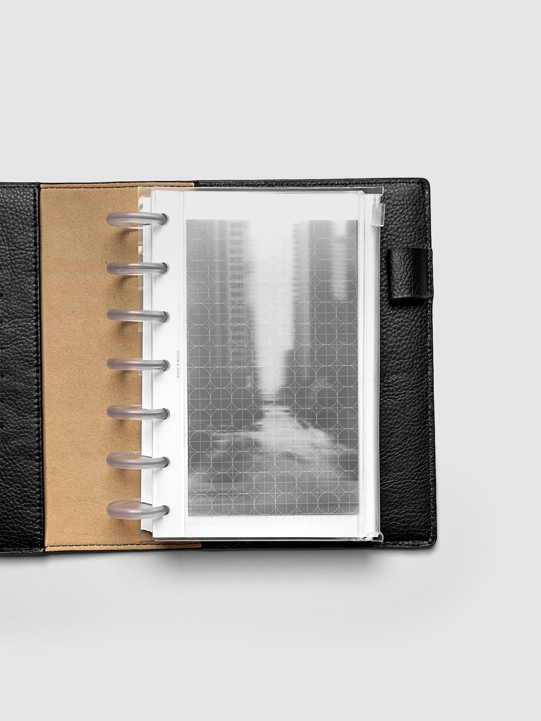 Side zipper transparent storage pouch for planners with decorative inner graph and photograph layers shown in a HP Mini planner folio cover.
