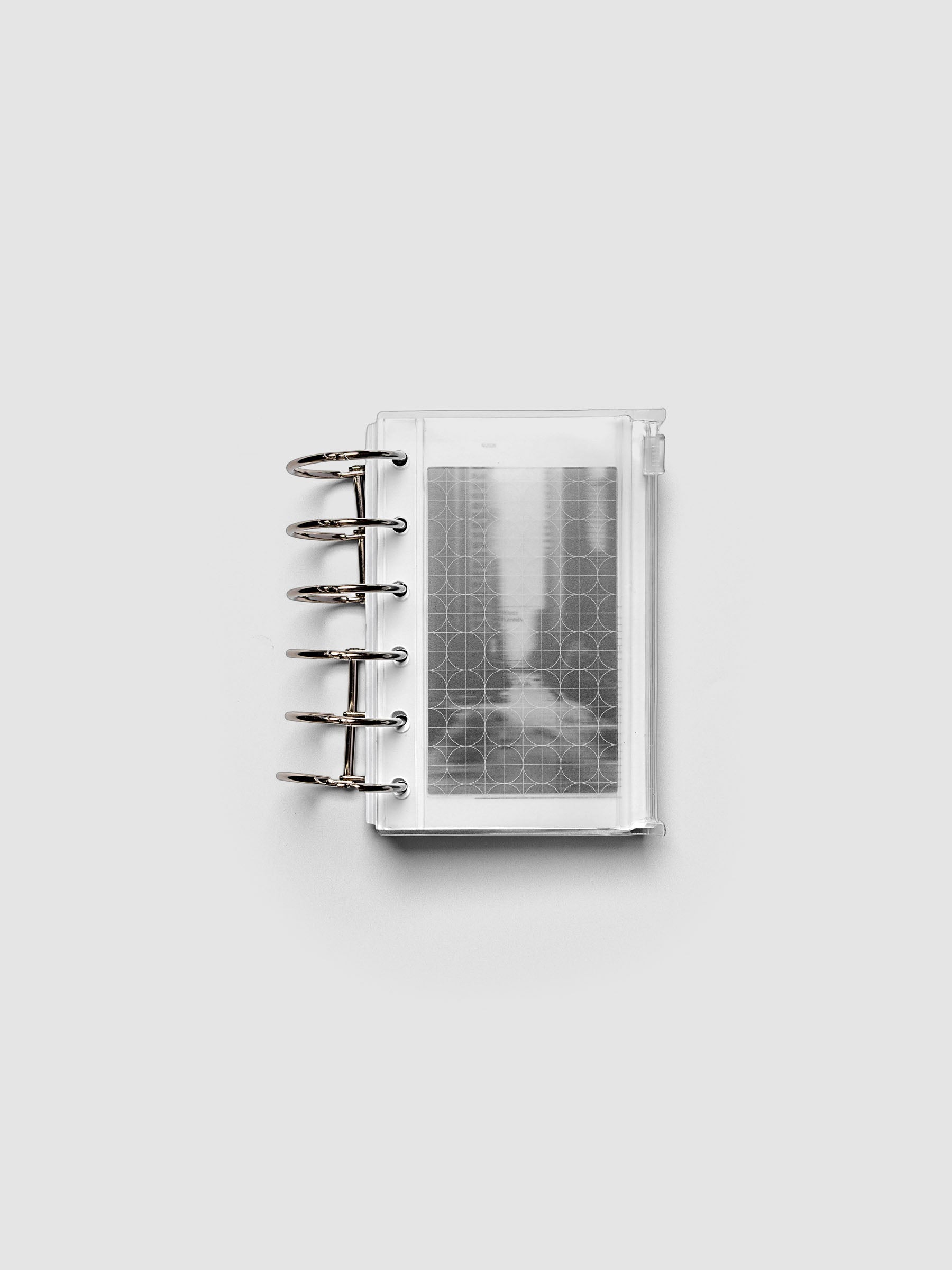 Side zipper transparent storage pouch for planners with decorative inner graph and photograph layers shown ring bound in size Pocket.
