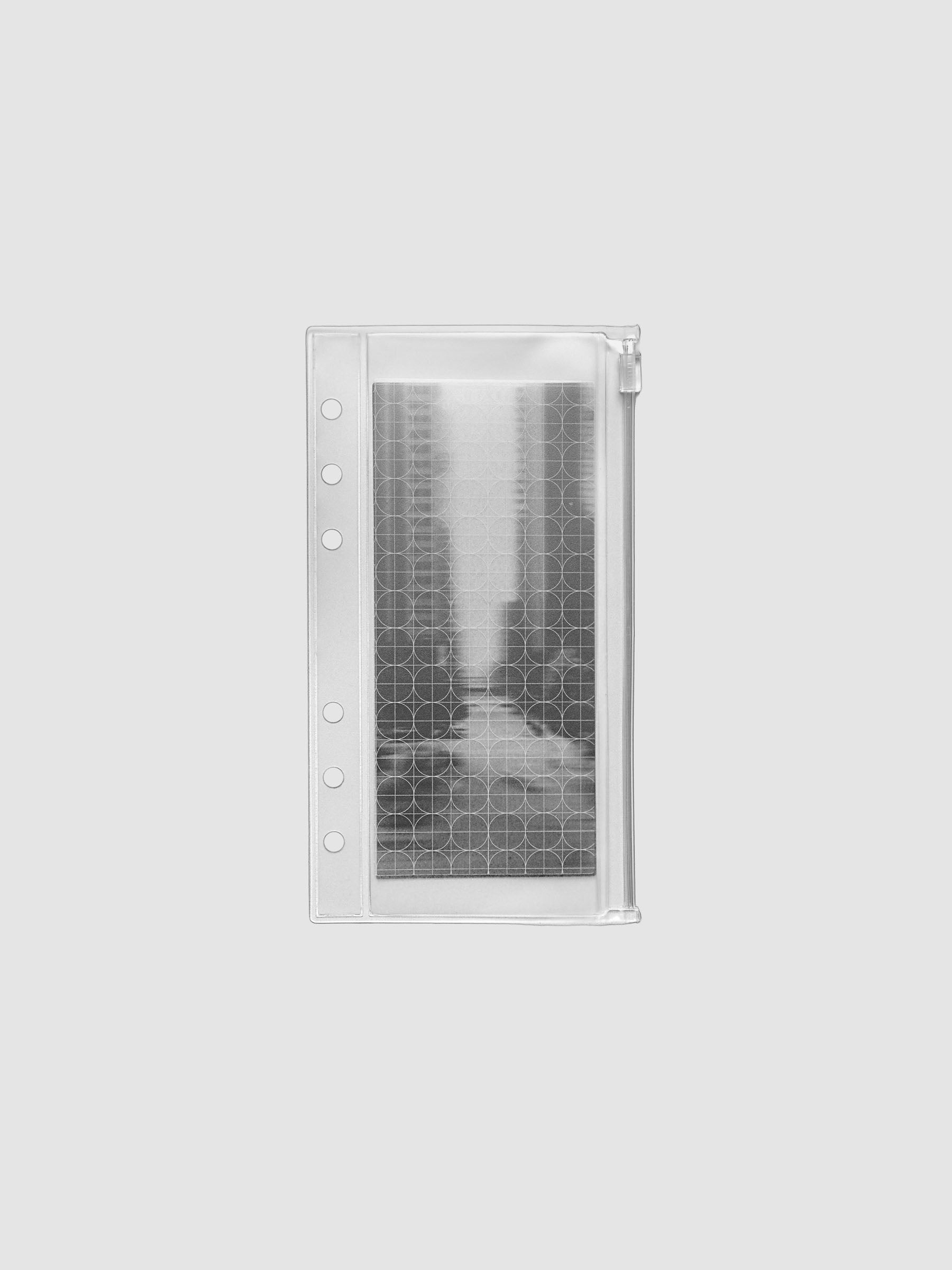 Zippered transparent pouch pre-punched for Personal size ring bound planners and notebooks. Features a graph and a photographic decorative inner insert.