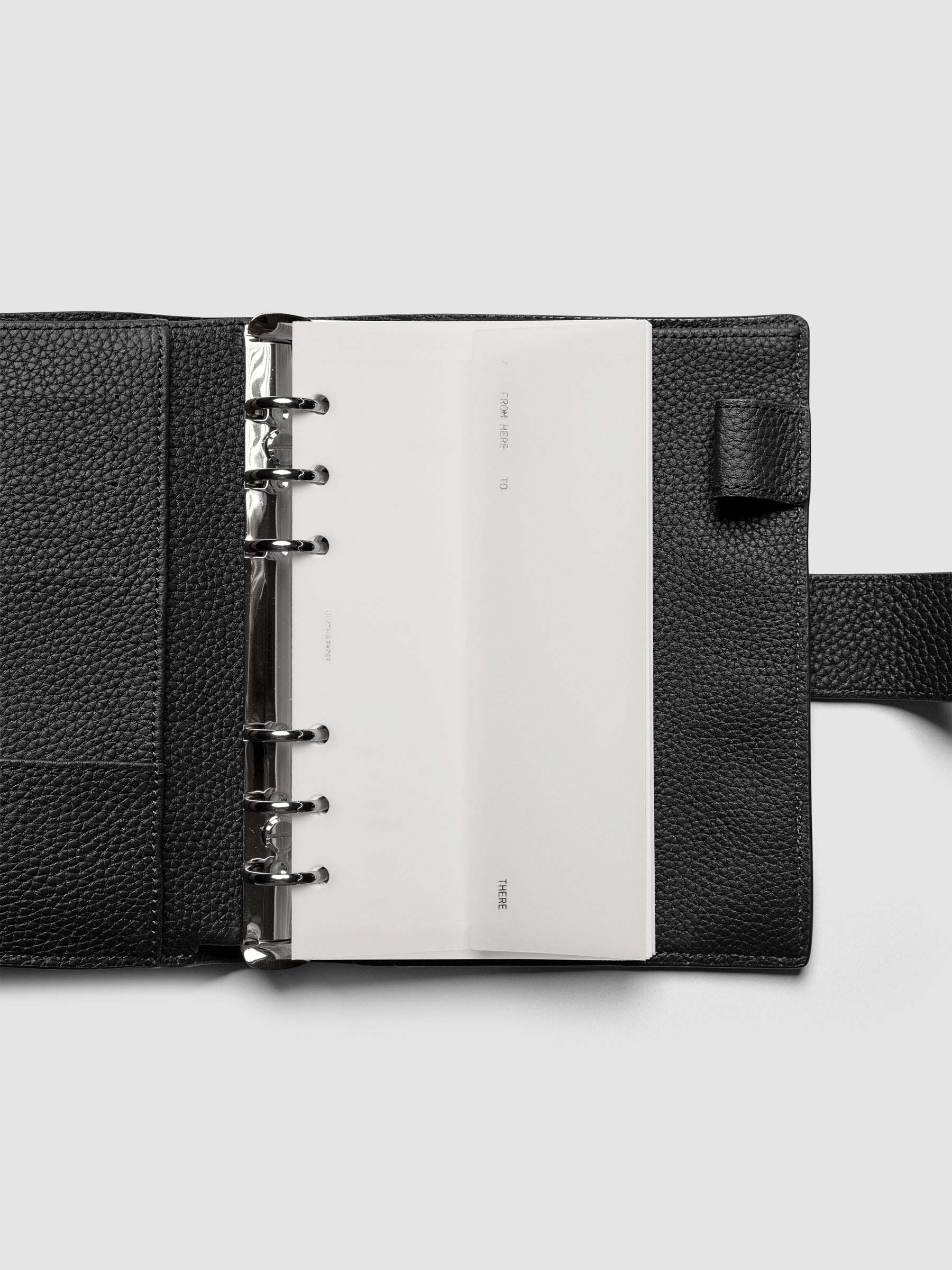 White Envelope Storage Holder shown inside a black, leather Pocket agenda.