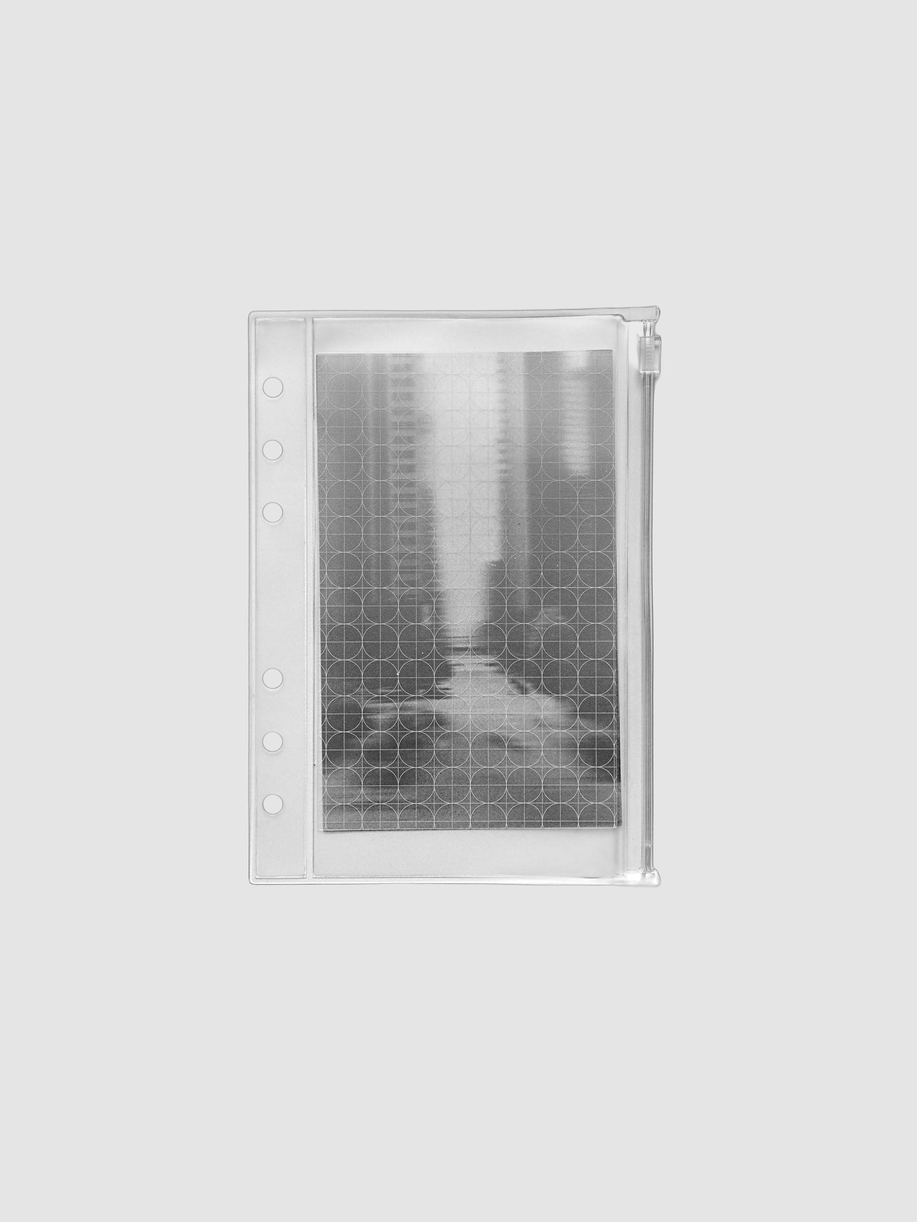 Zippered transparent pouch pre-punched for Personal Wide size ring bound planners and notebooks. Features a graph and a photographic decorative inner insert.