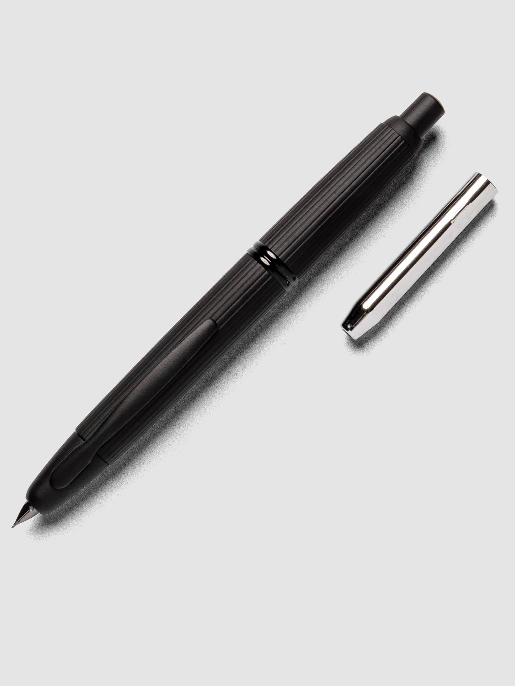 Black Stripes Pilot Vanishing Point Fountain Pen with cap off on a neutral background.