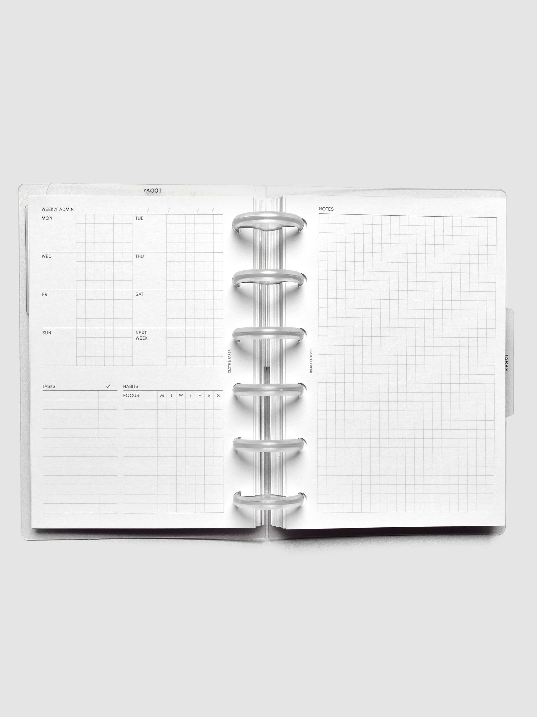 Open discbound planner showing a undated monday start weekly admin page on the left and a graph notes page on the right.