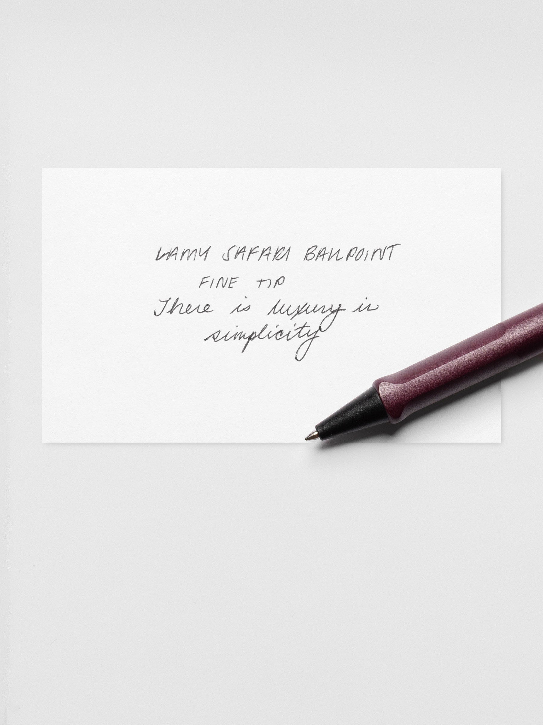 Paper with handwritten notes written with the LAMY Safari Ballpoint Pen | Scarlett | Fine, shown laying across the paper.