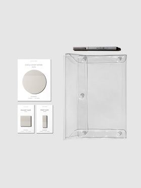 Color Bundle, Angora, Cloth & Paper. Matching set of circle sticky notes, page flags, and square page flags positioned next to a Uni Pin Marking Pen and Essentials Clear pouch. Sticky note color is Angora.