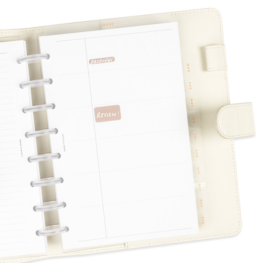 Today tab divider in use inside a discbound planner system. There are sticky notes placed behind it to show its transparency and sample text is written on the divider with white dry-erase ink.