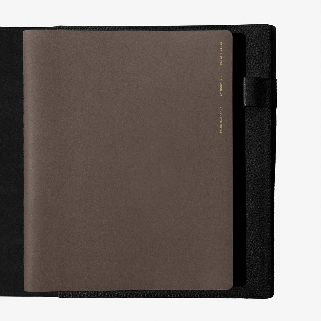 Notebook shown closed inside a black leather agenda. Color shown is Cafe Noir.