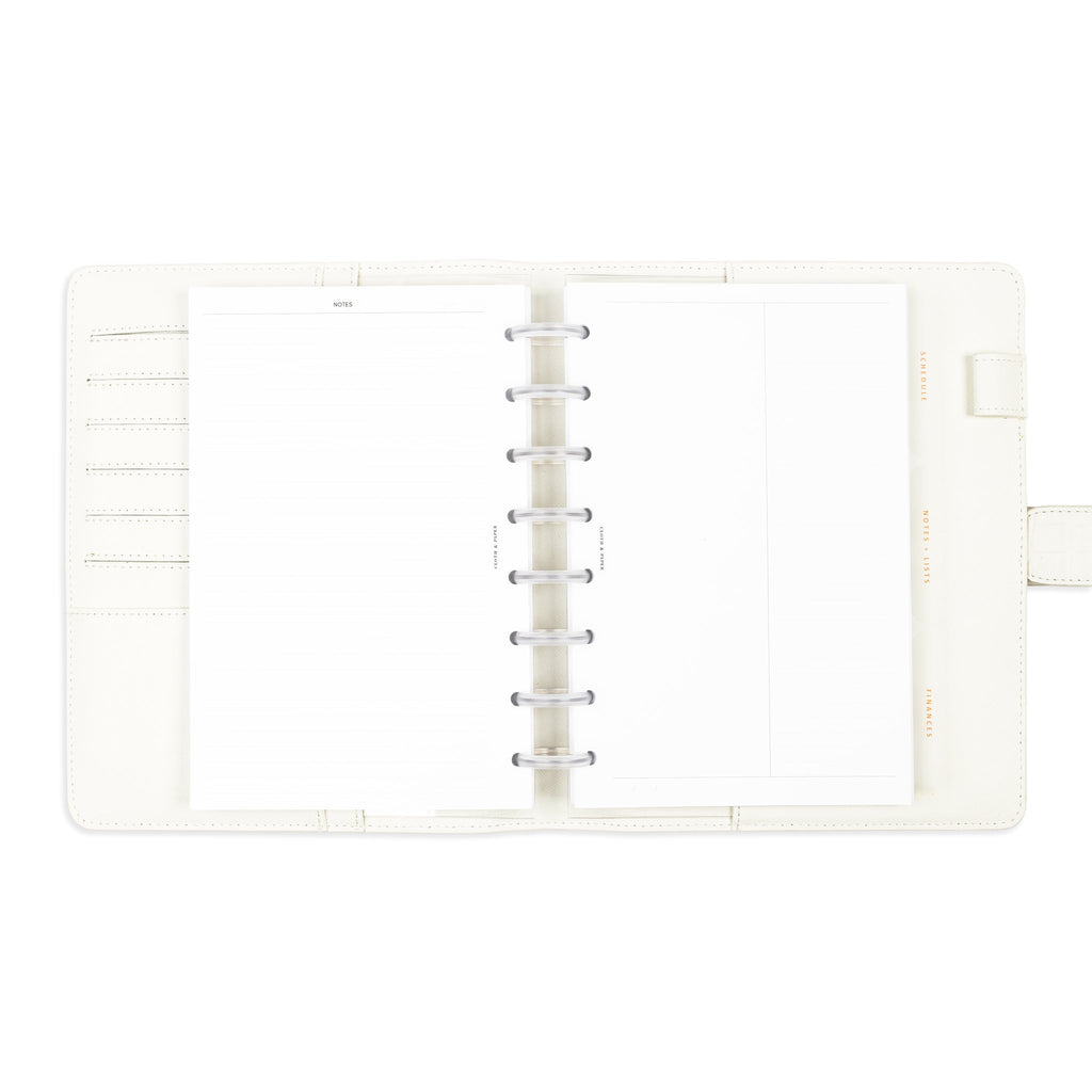 Tab dividers in use inside a discbound system housed in a white planner folio.