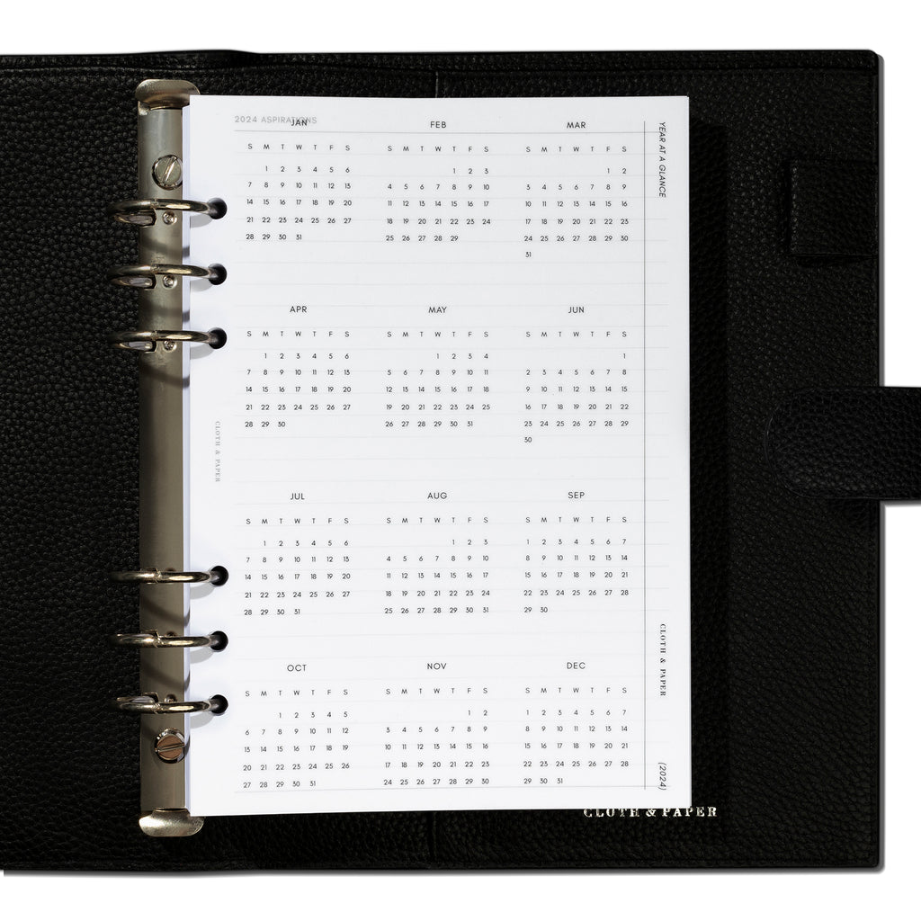 A5 dashboard shown in use inside a black leather planner.