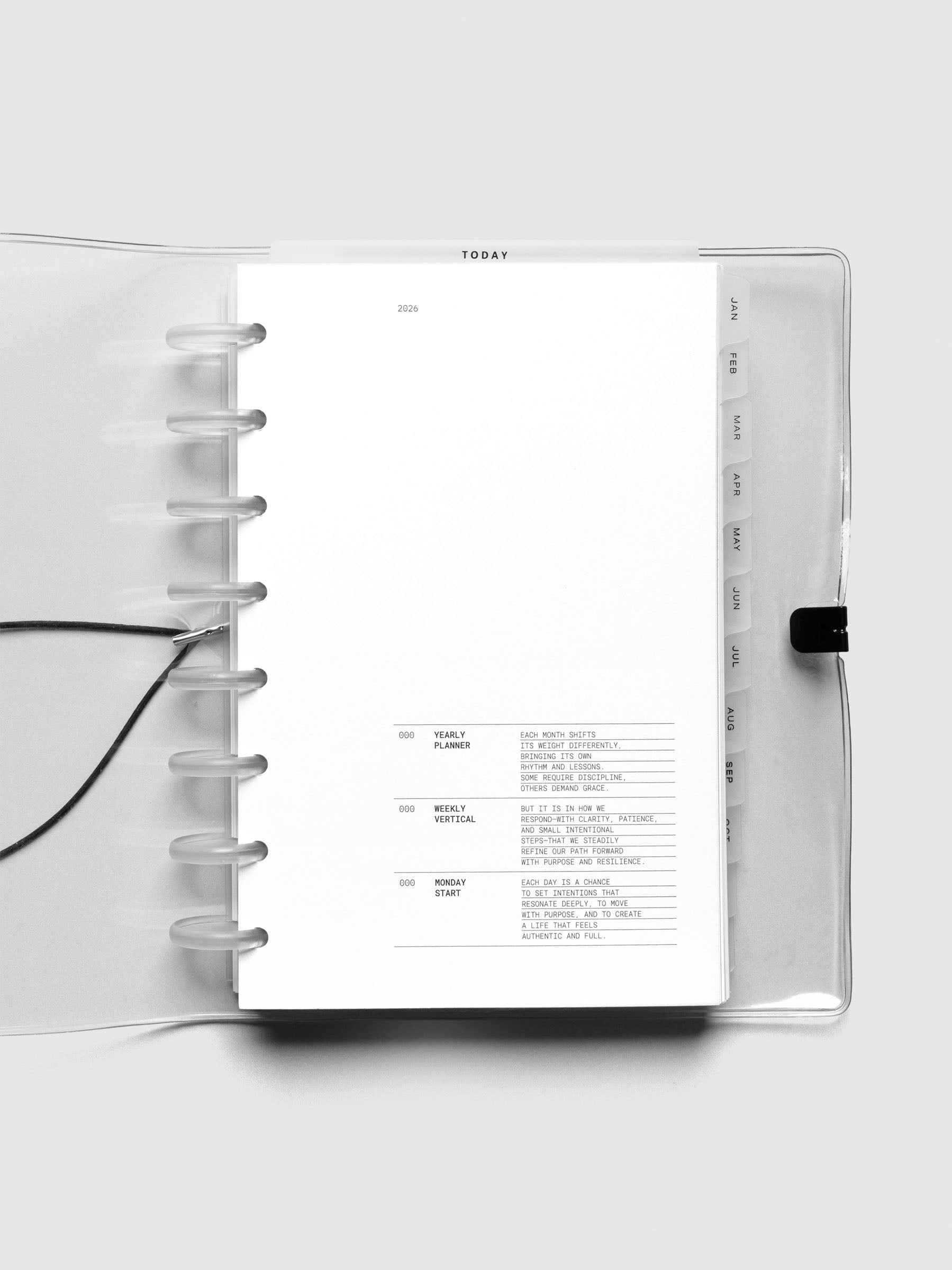 Interior view of open Half Letter planner showing 2026 insert and tab dividers inside the clear discbound cover.