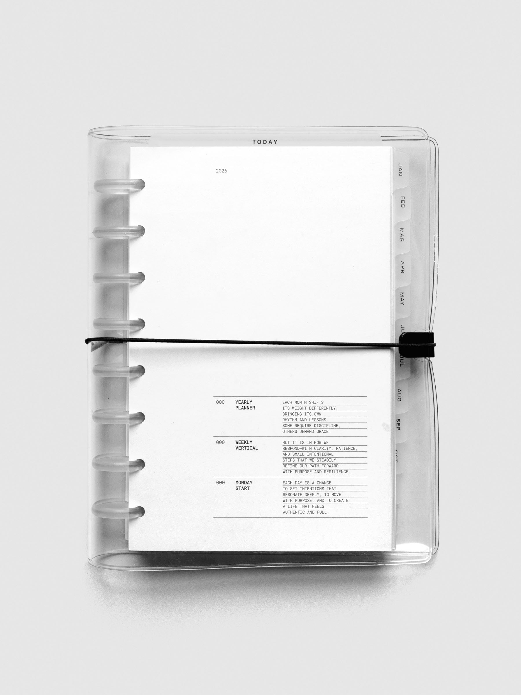 Top-down view of Half Letter bundle fully assembled in clear vinyl discbound cover, showcasing the 2026 dated insert and tab dividers.
