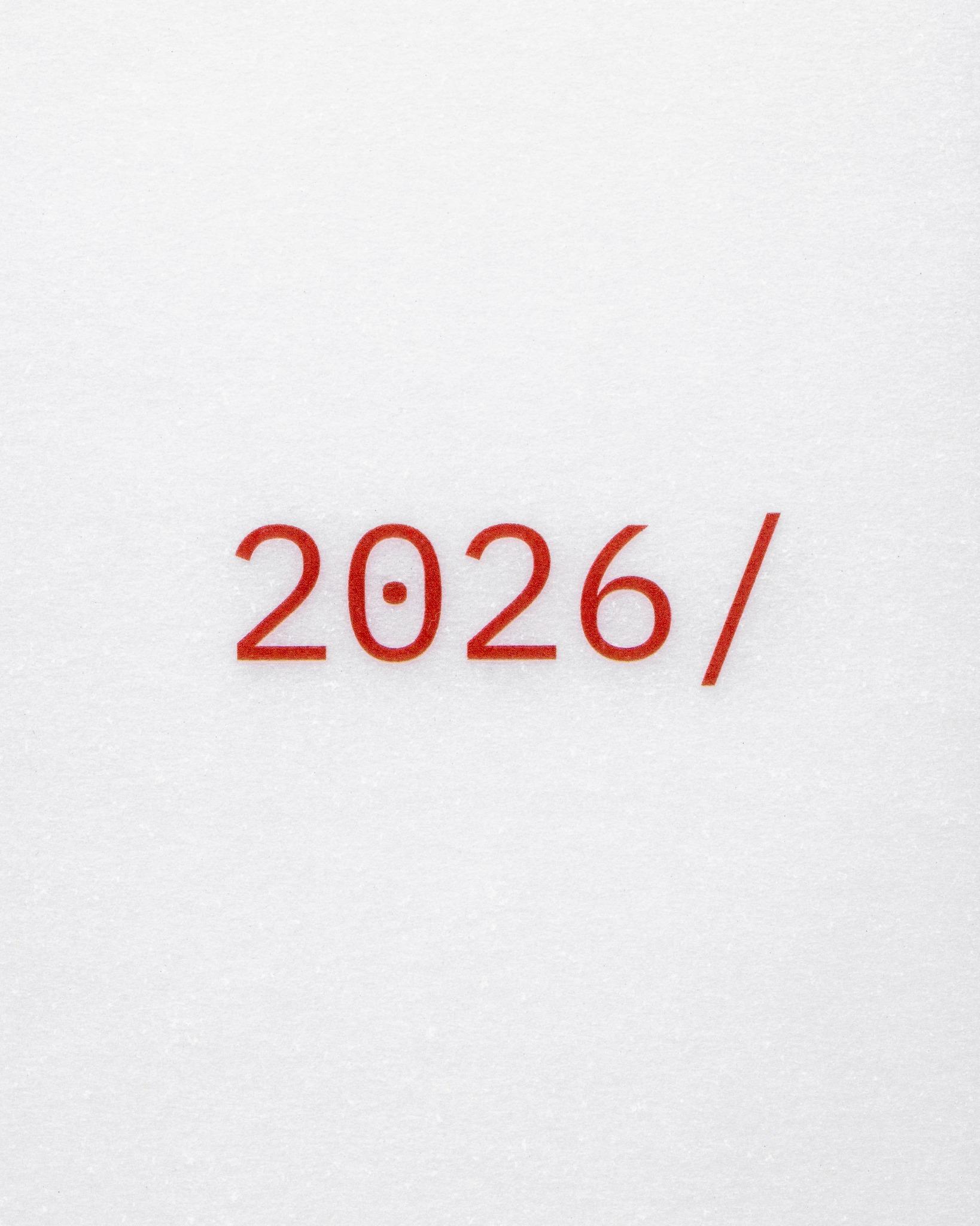 Close-up of red '2026/' typography printed on translucent vellum paper.