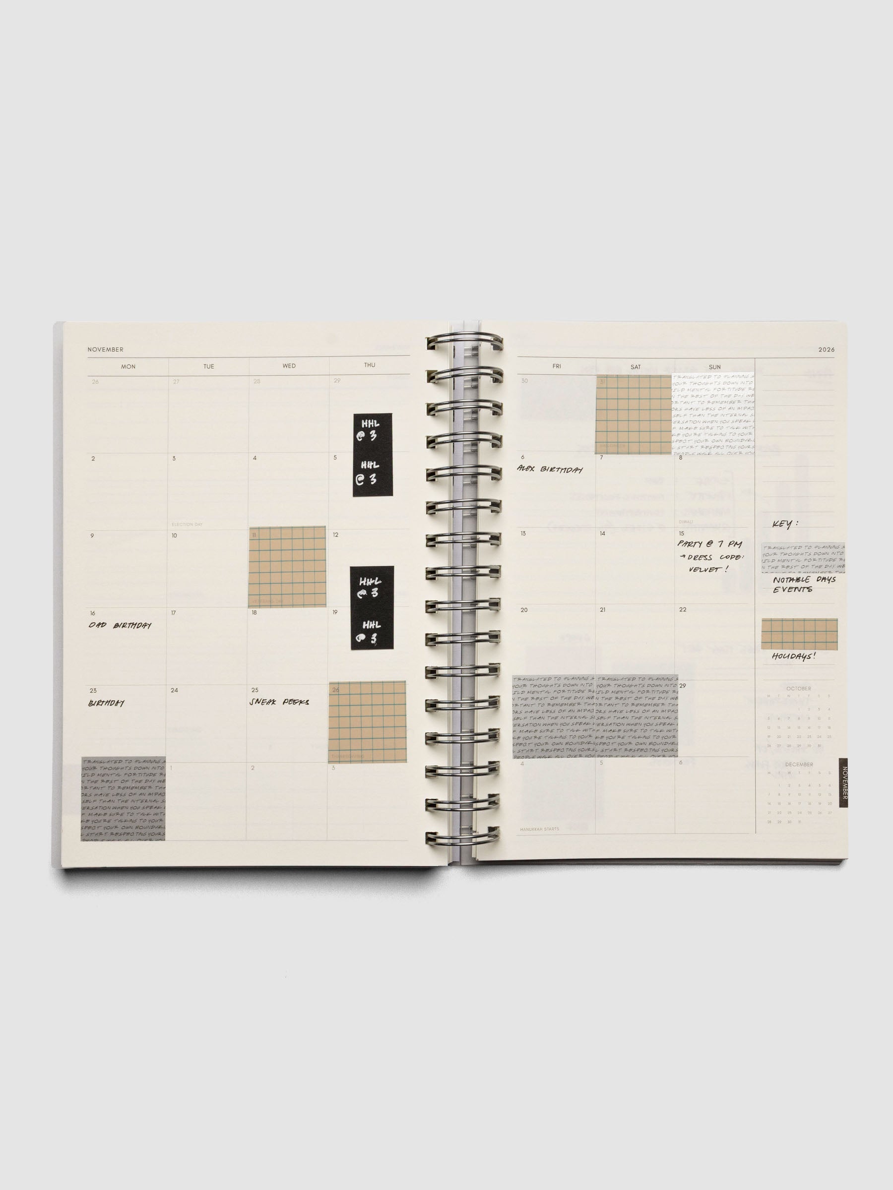 Inside of the 2026 Weekly Horizontal Notebook | Monday Start | A5 Spiral on a monthly overview page with handwritten example uses and square page flags.