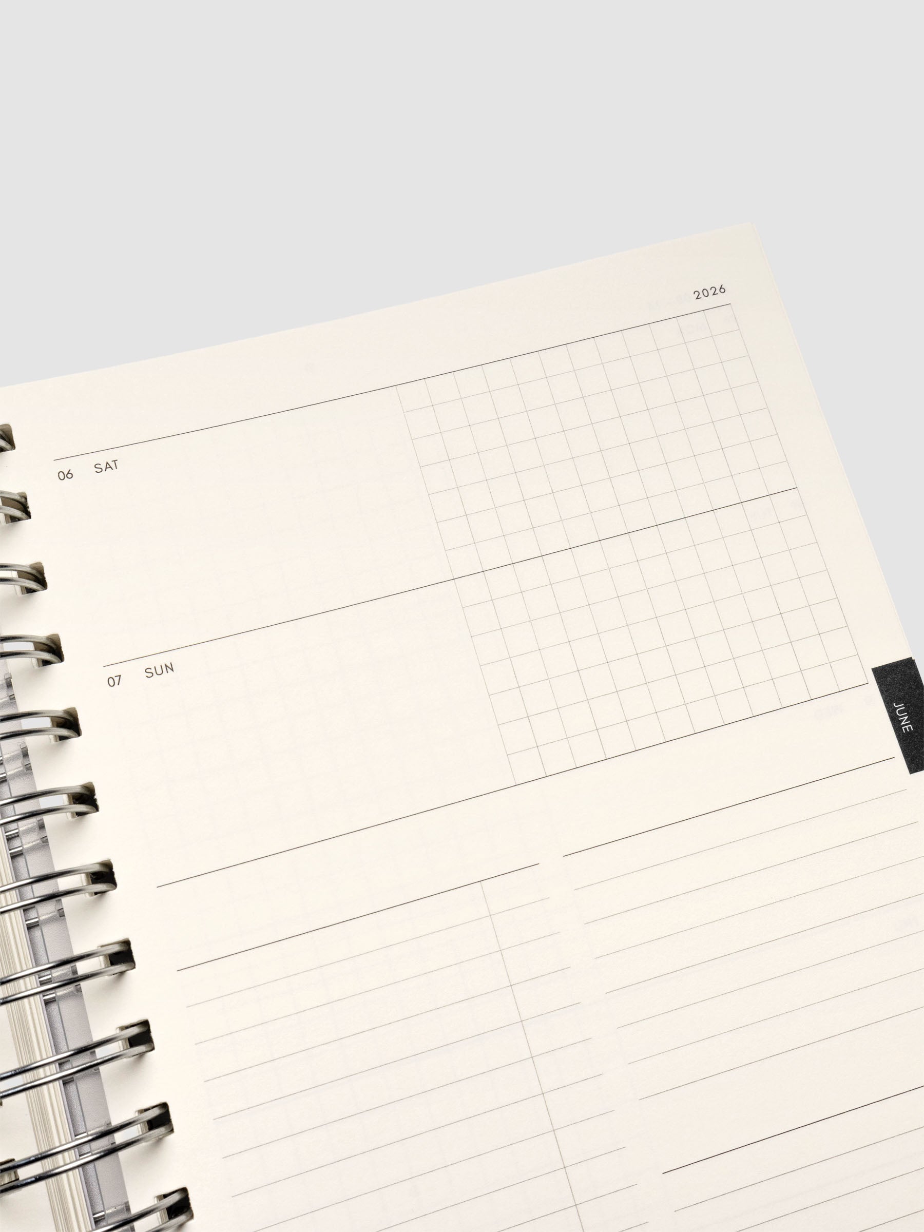 Close up of the inside of the 2026 Weekly Horizontal Notebook | Monday Start | A5 Spiral on a weekly layout spread showing blank space on the left hand side and graph notes on the right hand side for each day of the week. Below Saturday and Sunday are additional sections for notes and task lists.
