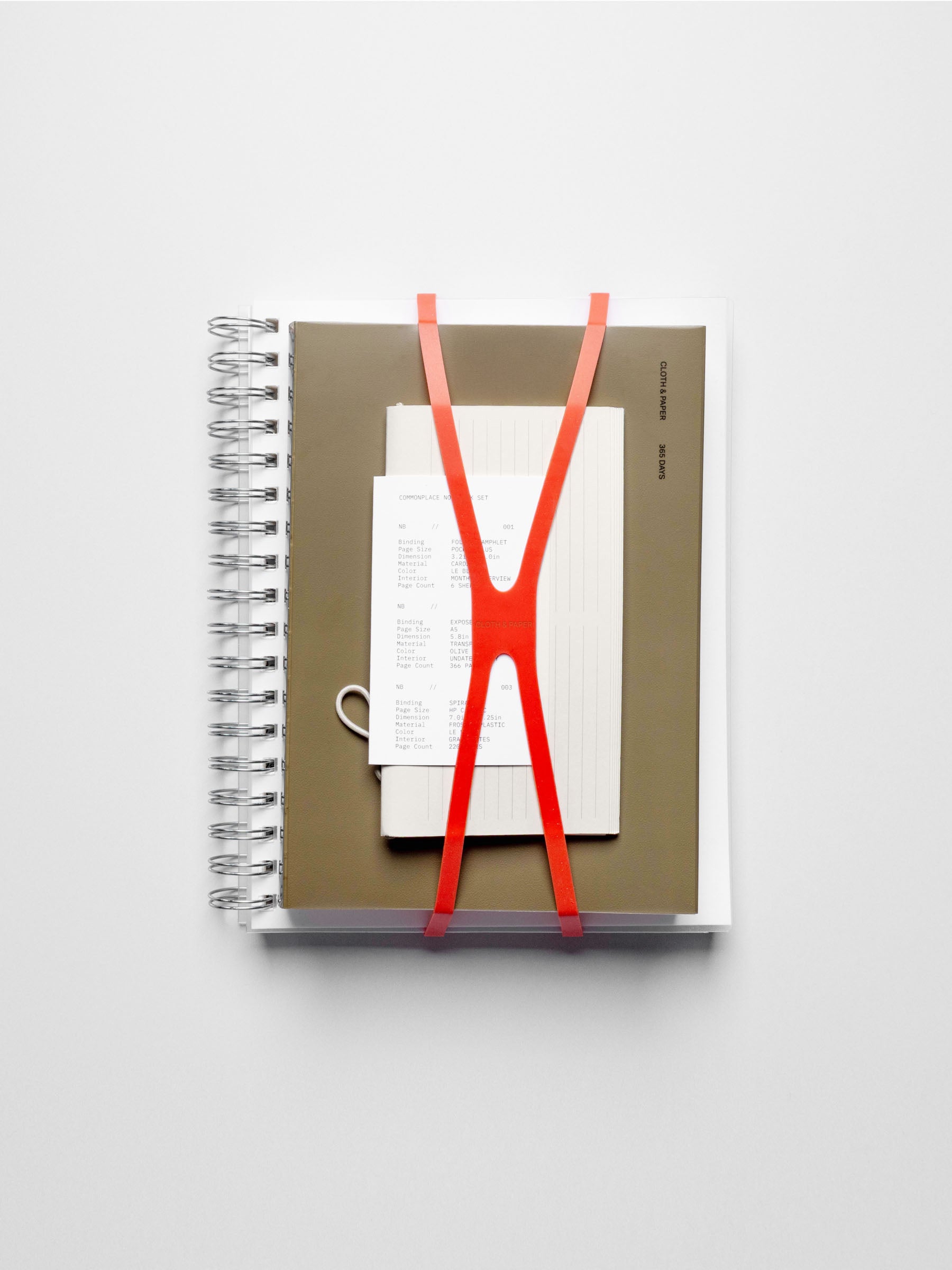 Set of three notebooks displayed on a neutral background.