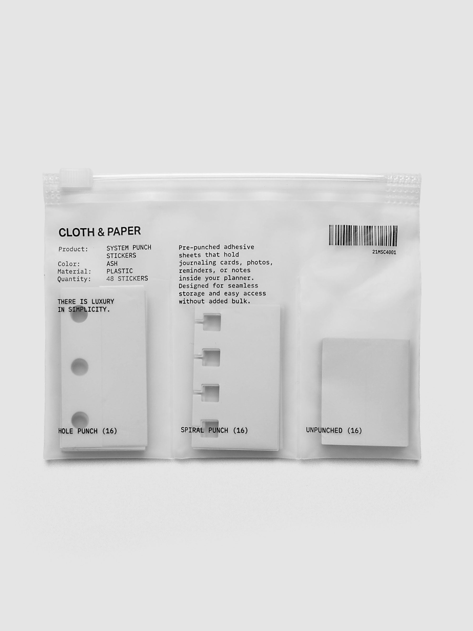 Clear zippered bag containing 48 system punch stickers for hole punch, spiral punch, and unpunched.
