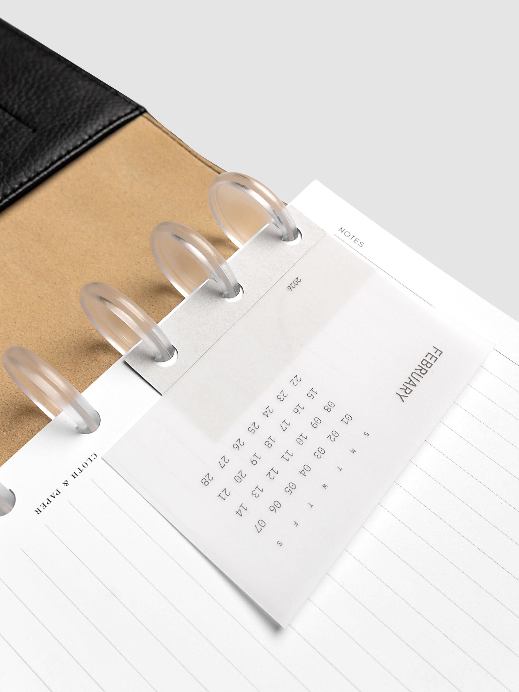 Disc punch system punch sticker with clear calendar card attached shown in a discbound planner.