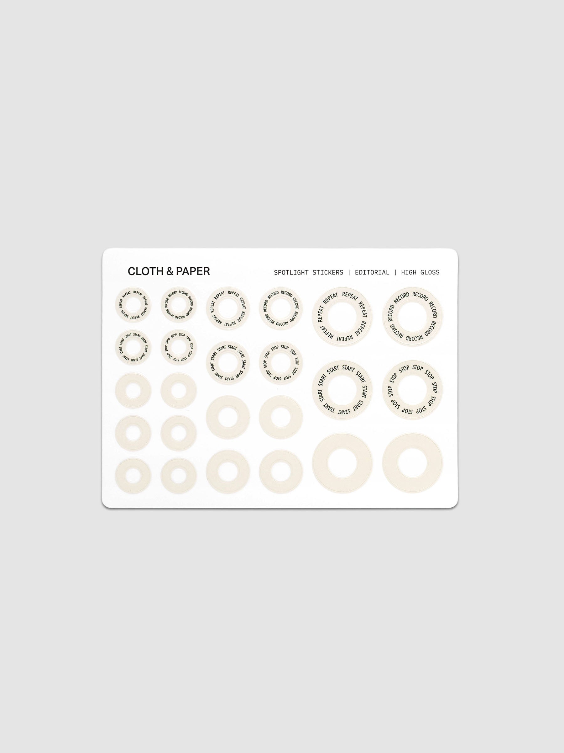 One sheet of Spotlight Stickers in Editorial (beige & black text) against a grey background.