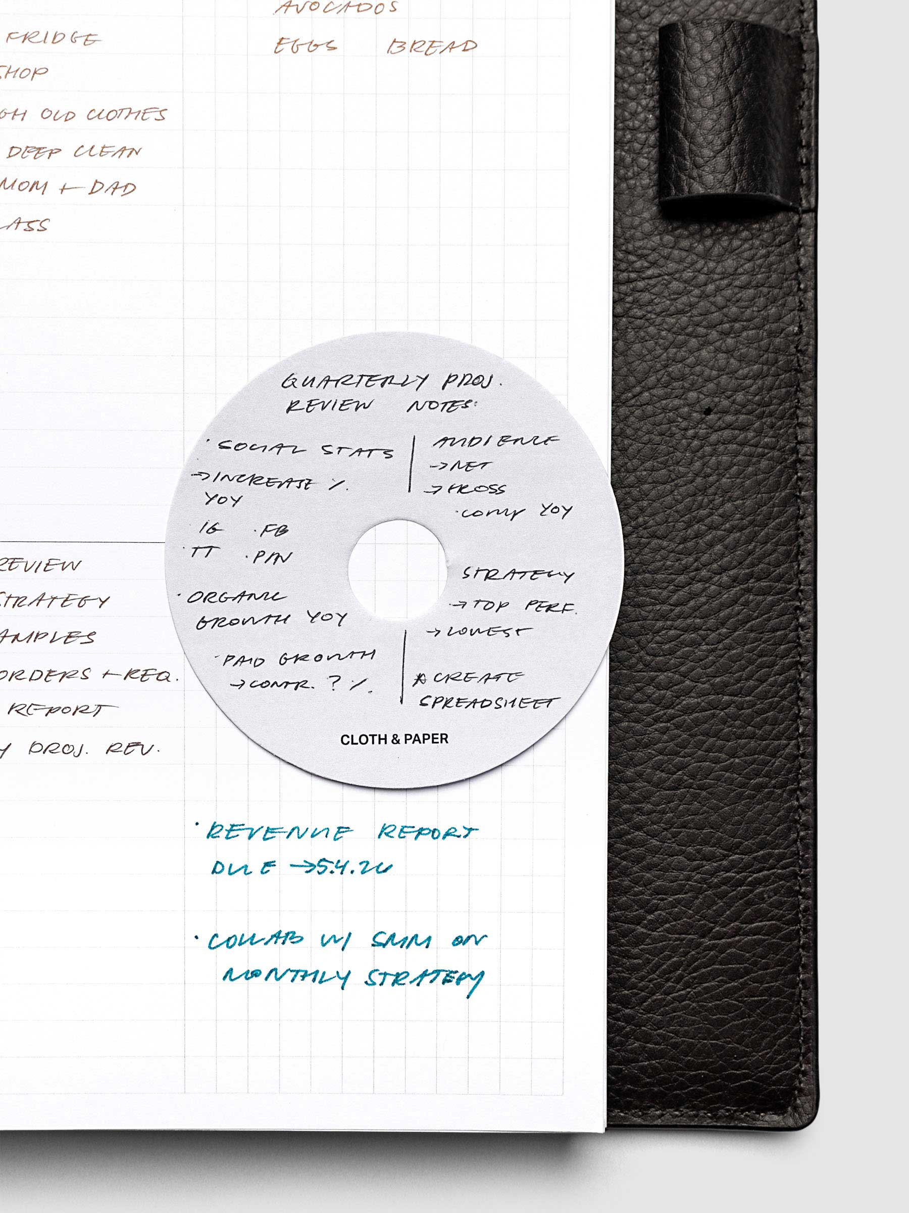 Spotlight Sticky Note in the color Ash shown inside of a planner with handwritten notes