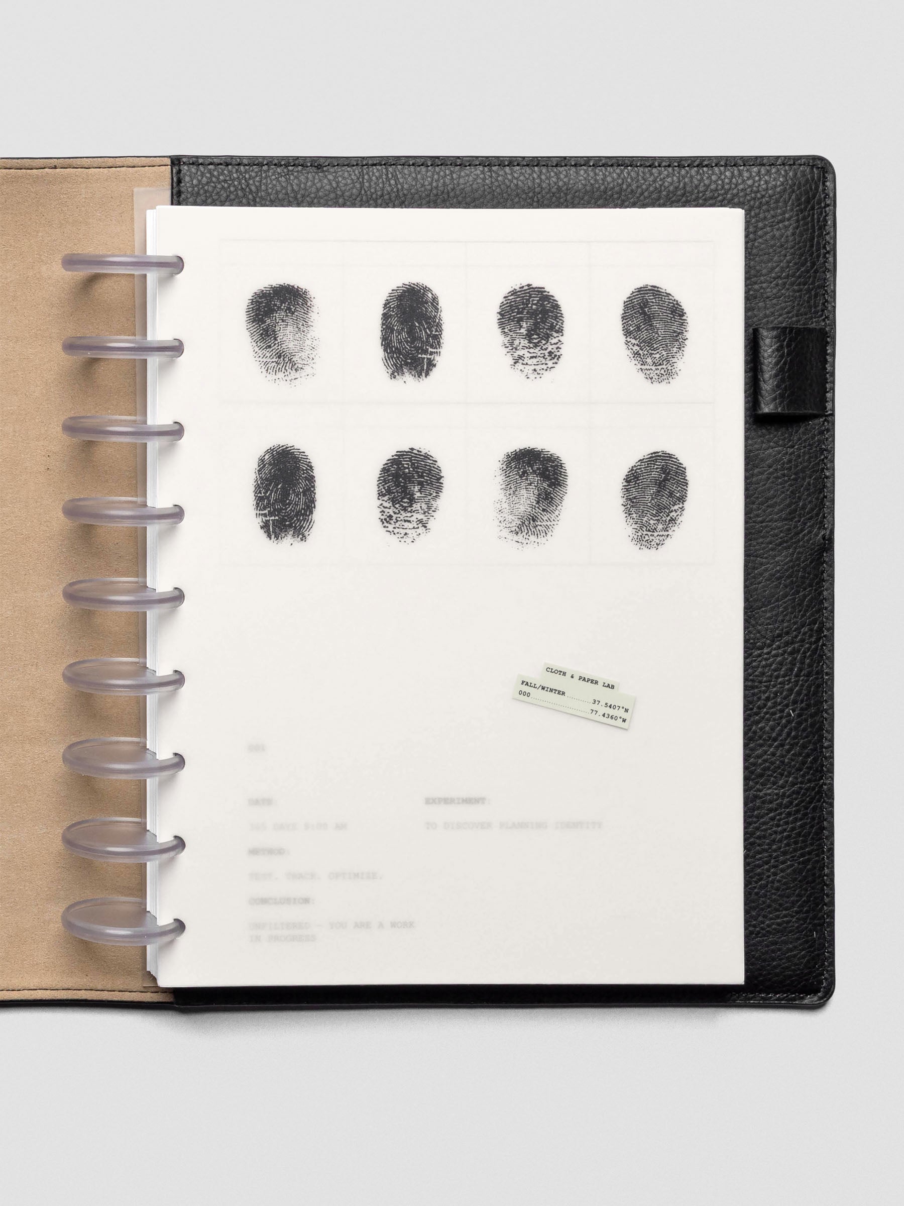 Two layered HP Classic sized planner dashboards, one semi-transparent, one matte, featuring a fingerprint design shown inside a leather folio.