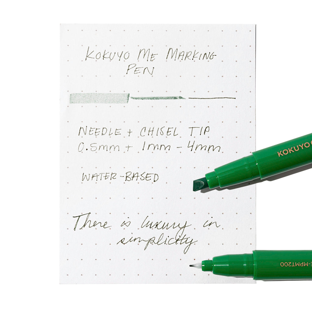 Two markers, showing the nib and chisel tips respectively, rest on an in use pen testing sheet. Color shown is Green Pepper. 