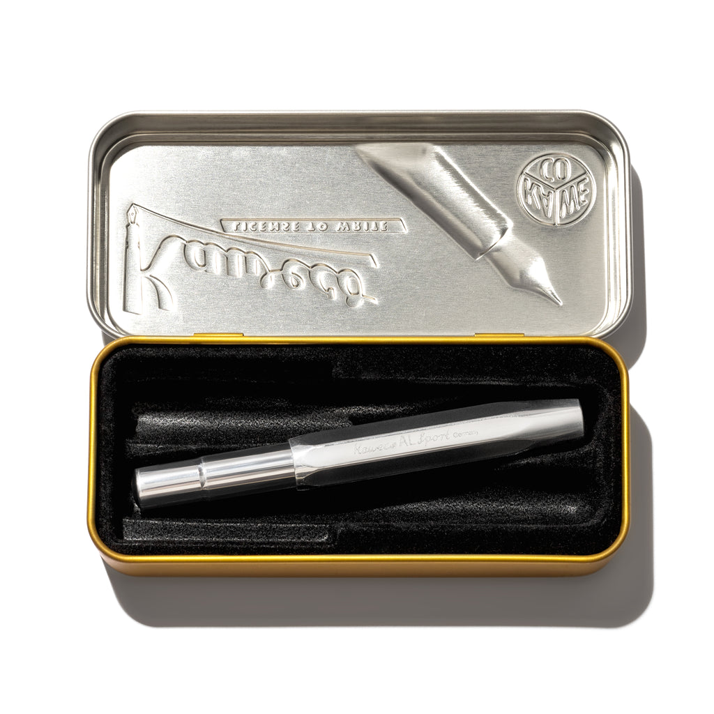 Pen displayed in its tin case on a white background.