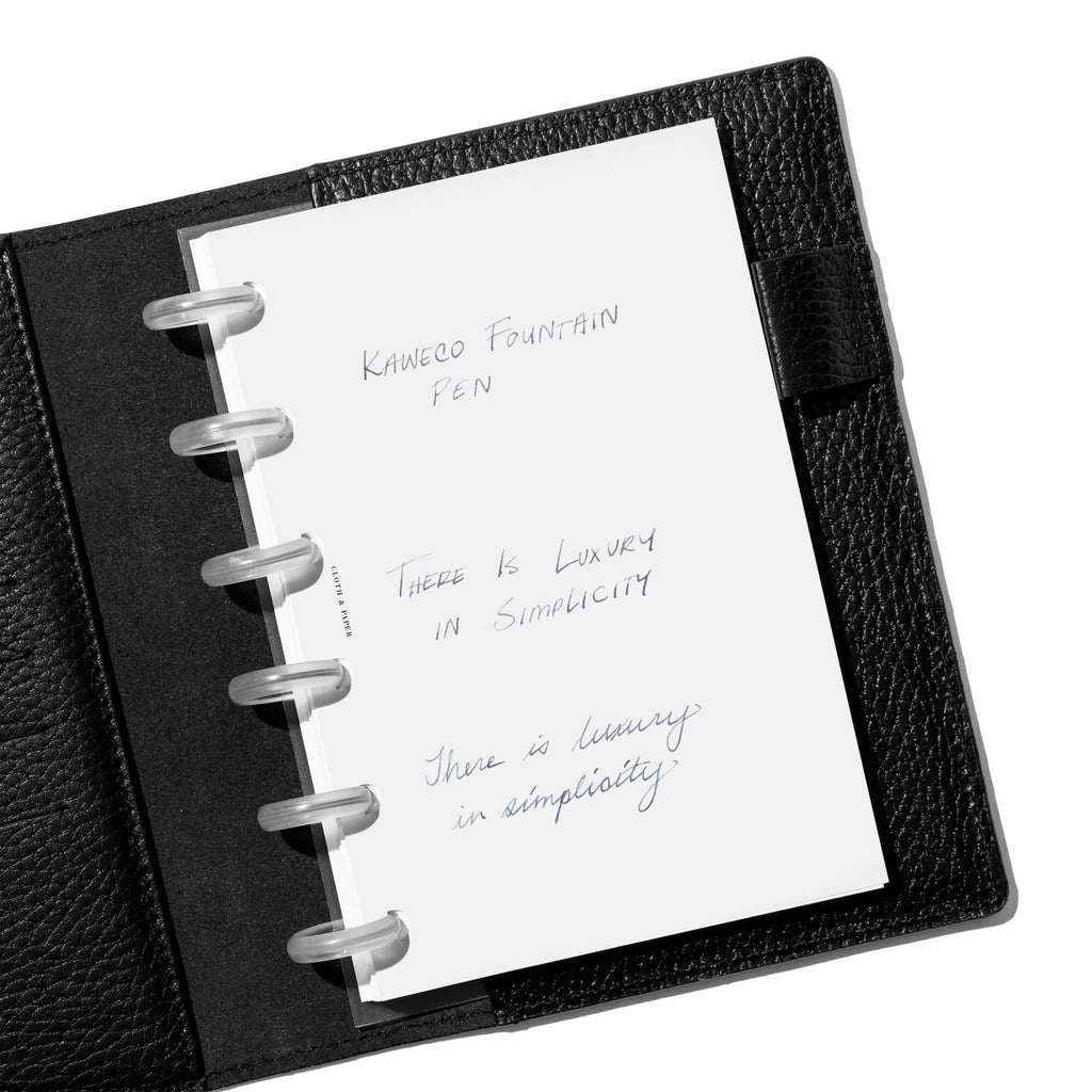 Writing sample shown in a black leather folio. 
