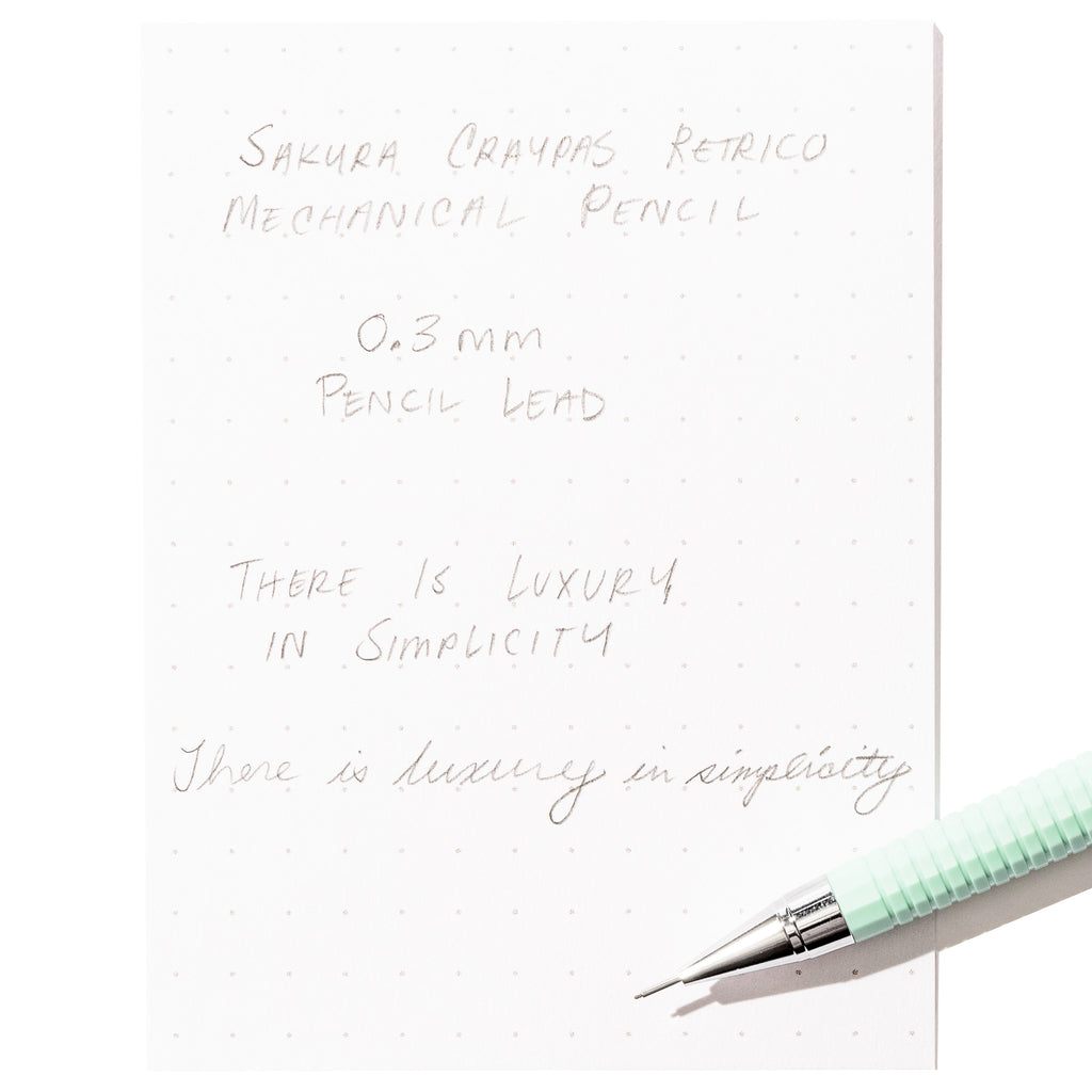 Writing sample with pencil displayed on a white background.