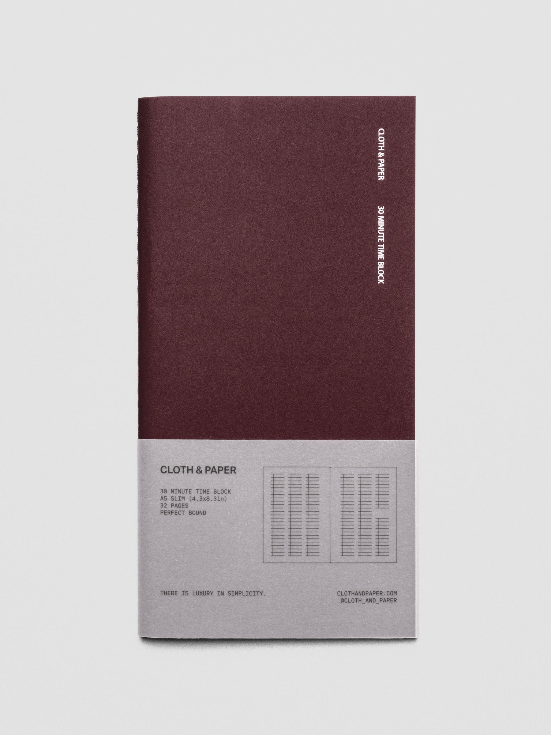 Travel Notebook in size A5 Slim in color Bordeux with 30 Minute Time Block pages shown from the front with packaging belly band.