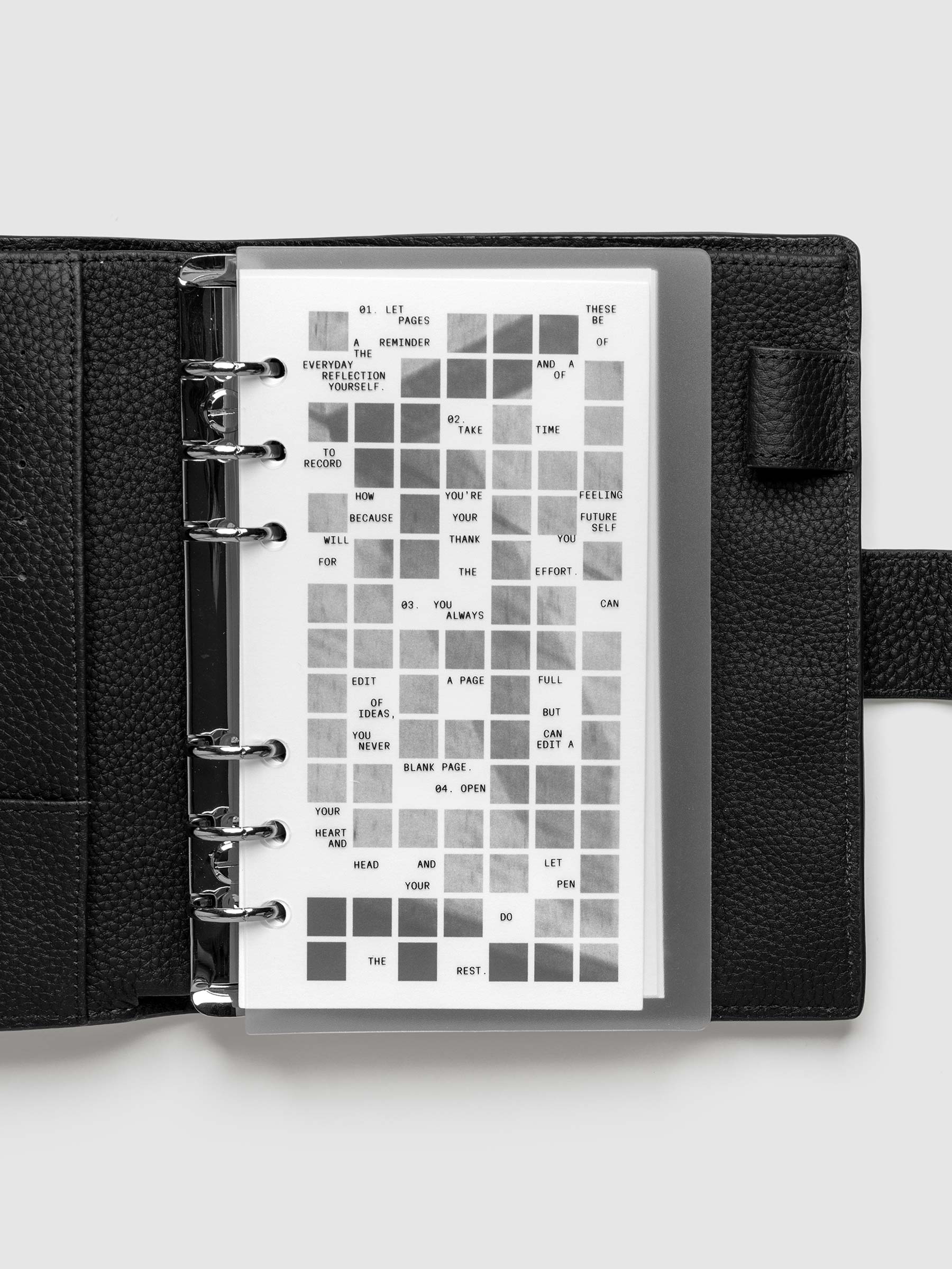 Clear planner cover with black printed text paired with a photographic black and white dashboard. Shown pre-punched for 6-ring planners in the size Personal in a black agenda.