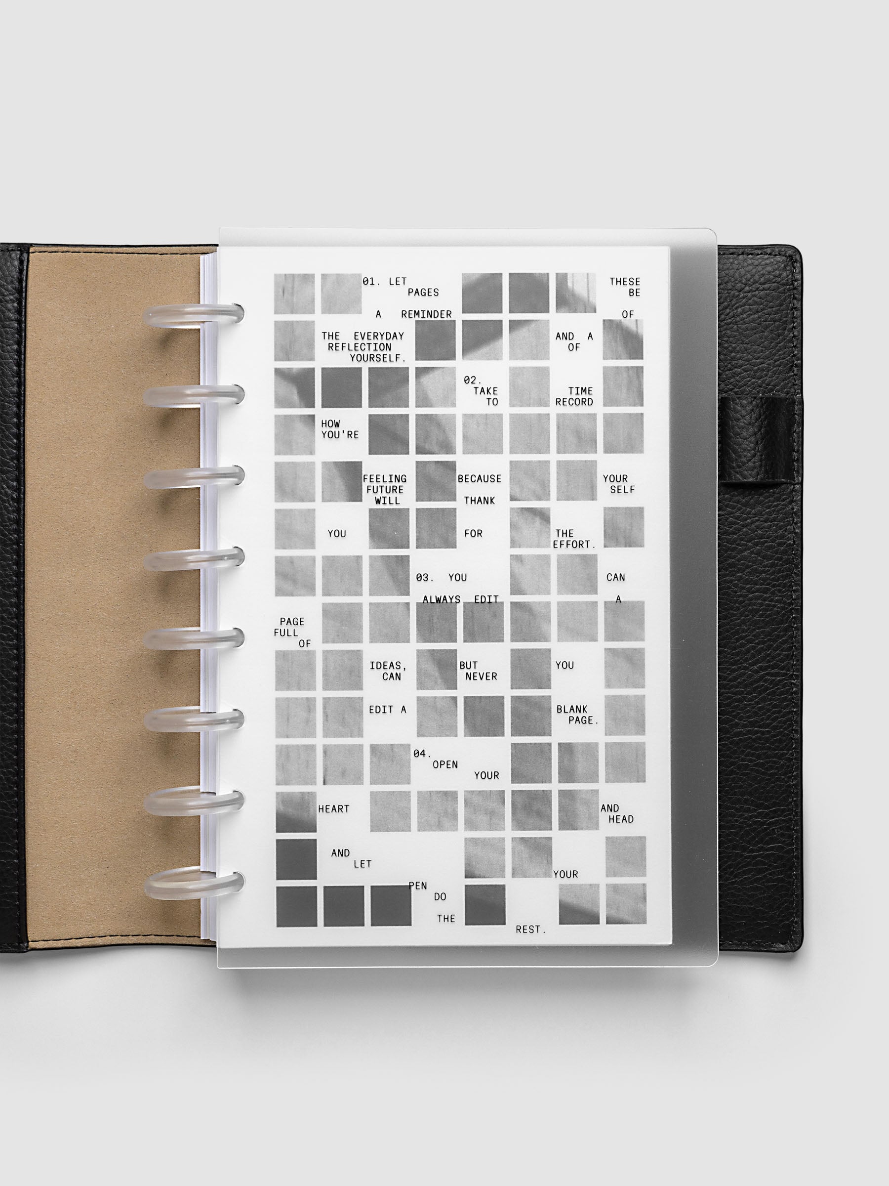 Clear planner cover with black printed text paired with a photographic black and white dashboard. Shown pre-punched for discbound planners in the size Half Letter in a black folio.