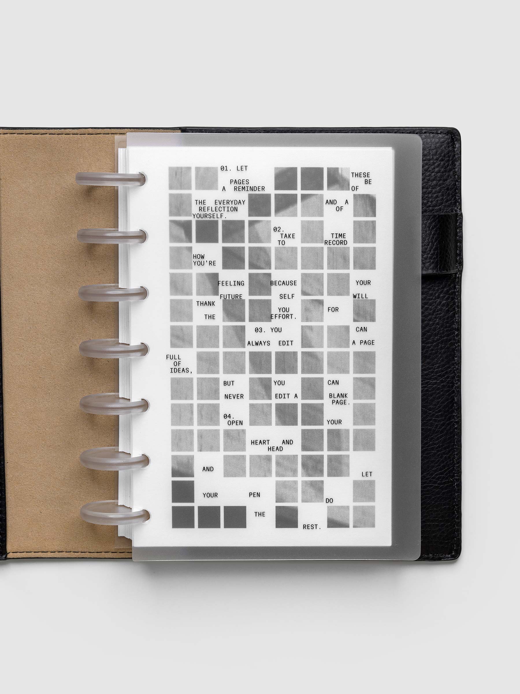 Clear planner cover with black printed text paired with a photographic black and white dashboard. Shown pre-punched for discbound planners in the size HP Mini in a black folio.