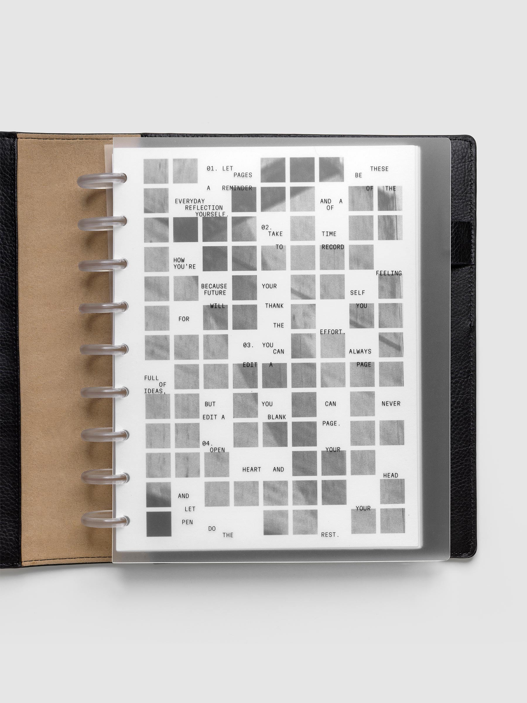 Clear planner cover with black printed text paired with a photographic black and white dashboard. Shown pre-punched for discbound planners in the size HP Classic in a black folio.