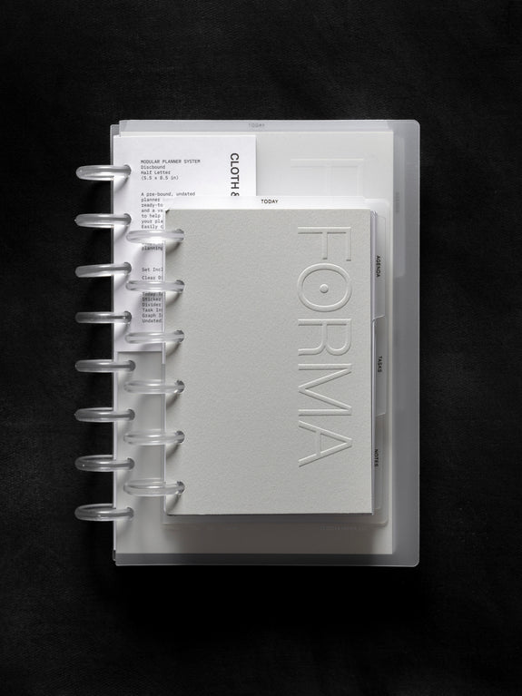 a white notebook with a book on it