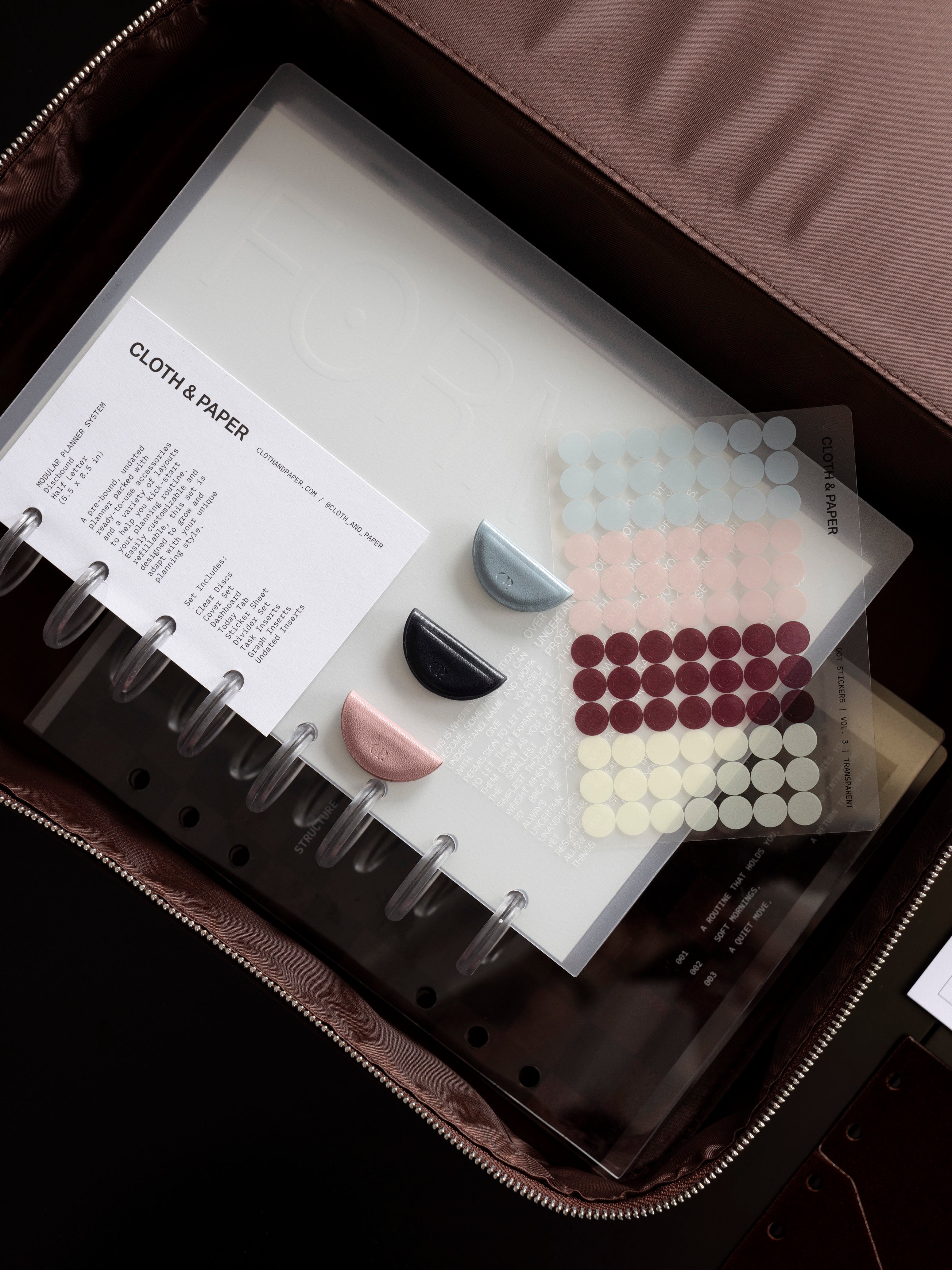 Three mini magnetic bookmarks shown alongside and on top of other Cloth & Paper products.