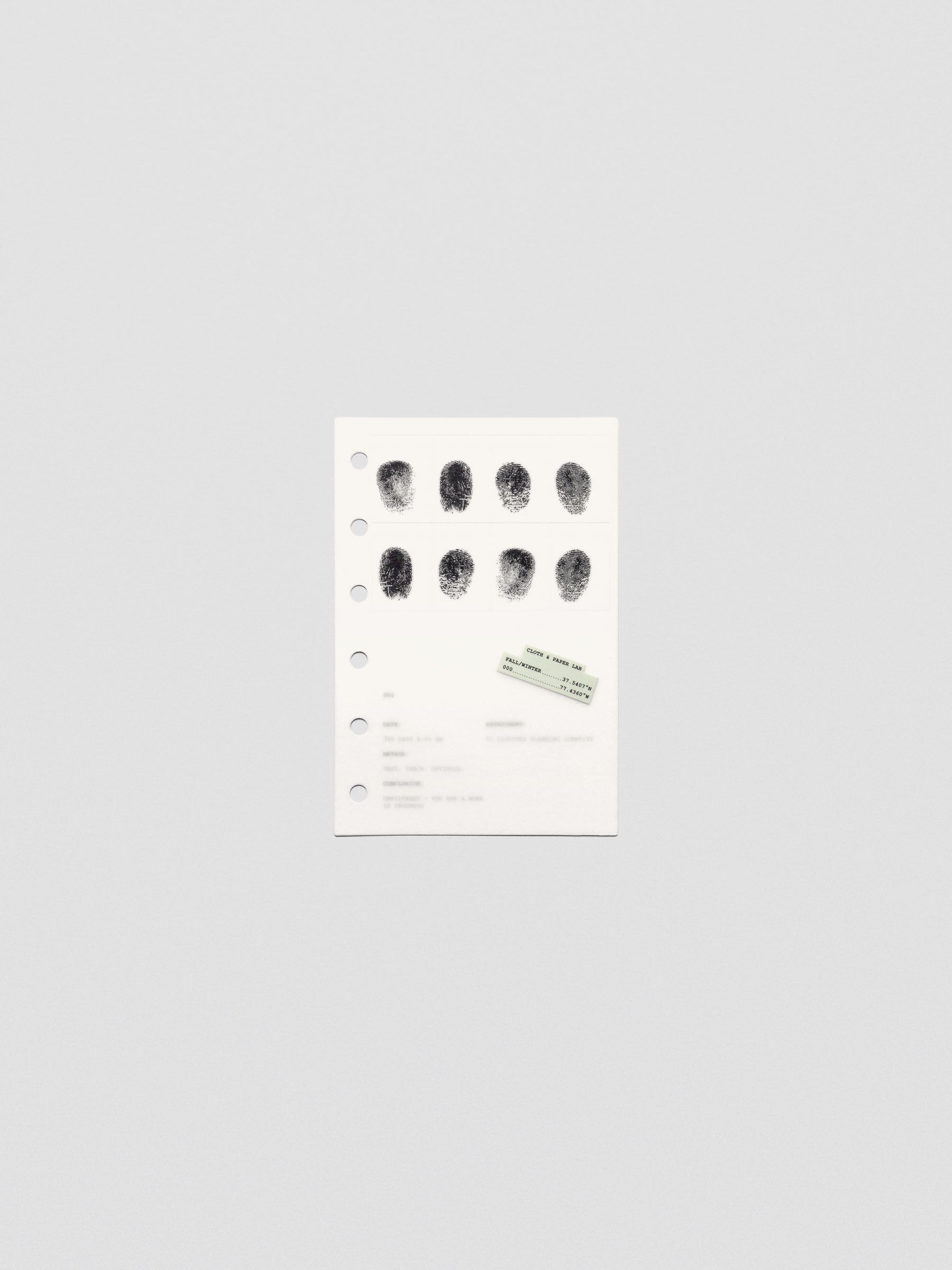 Two layered pocket sized planner dashboards, one semi-transparent, one matte, featuring a fingerprint design.