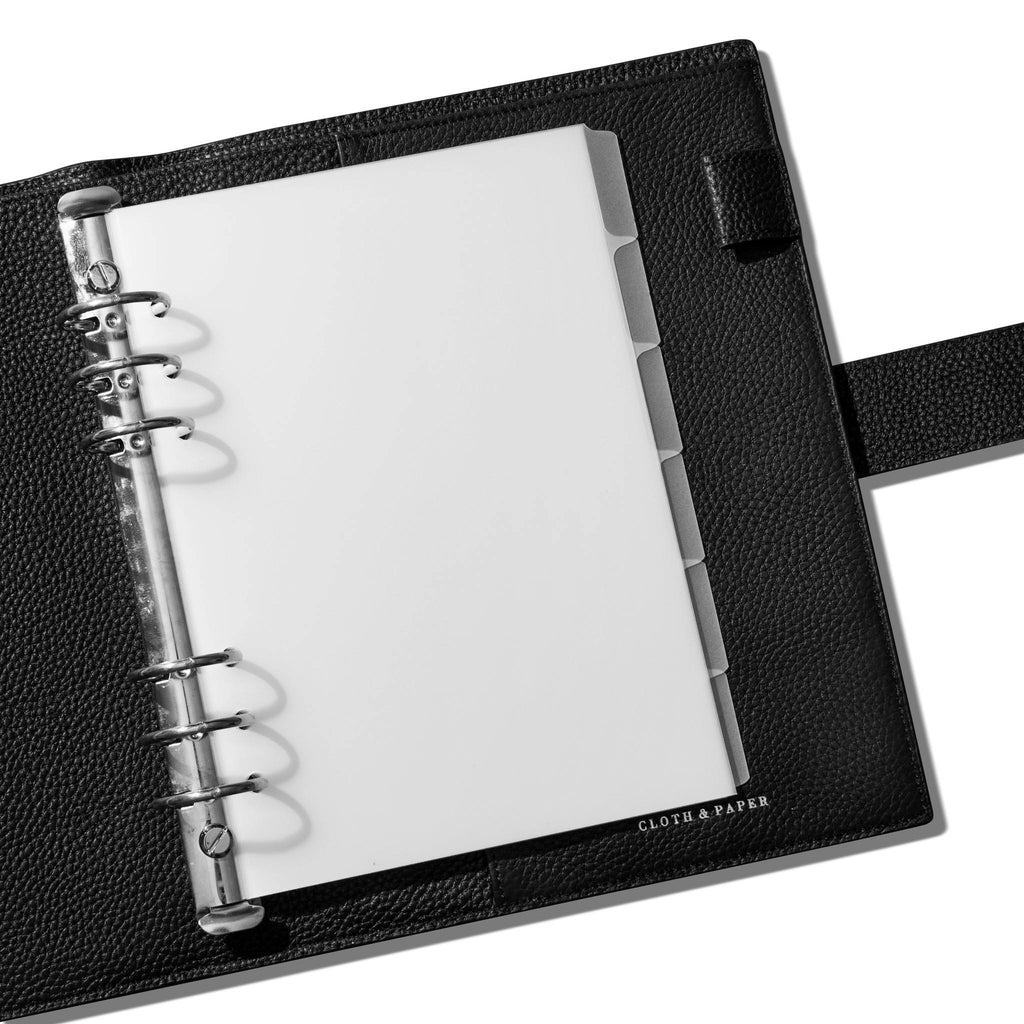 Dividers in use inside a black leather agenda.