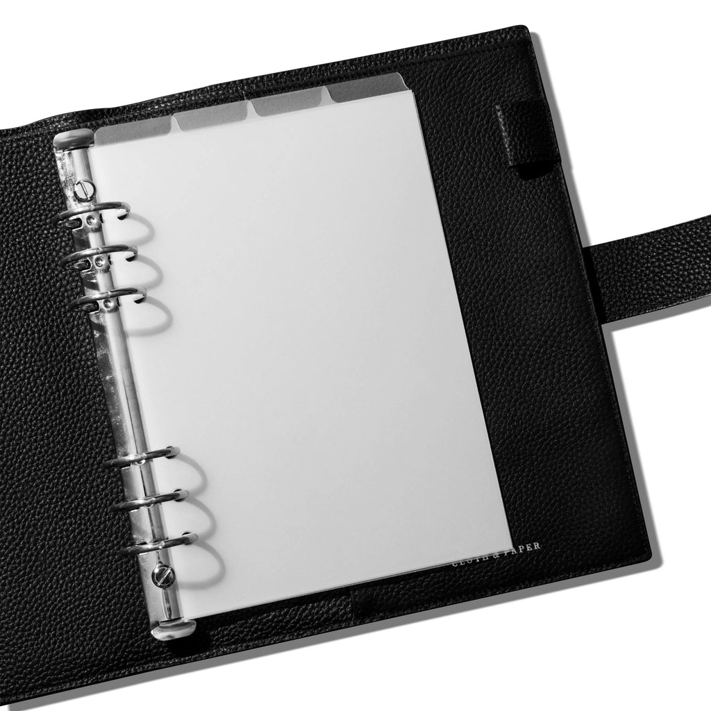 Dividers in use inside a black leather agenda.