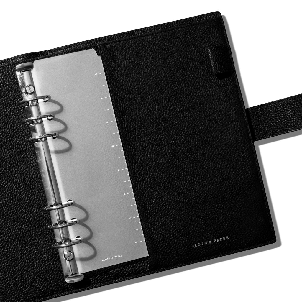Page marker in use inside a black leather agenda.