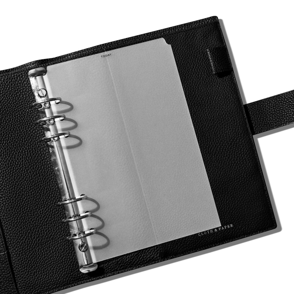 Divider in use inside a black leather planner.