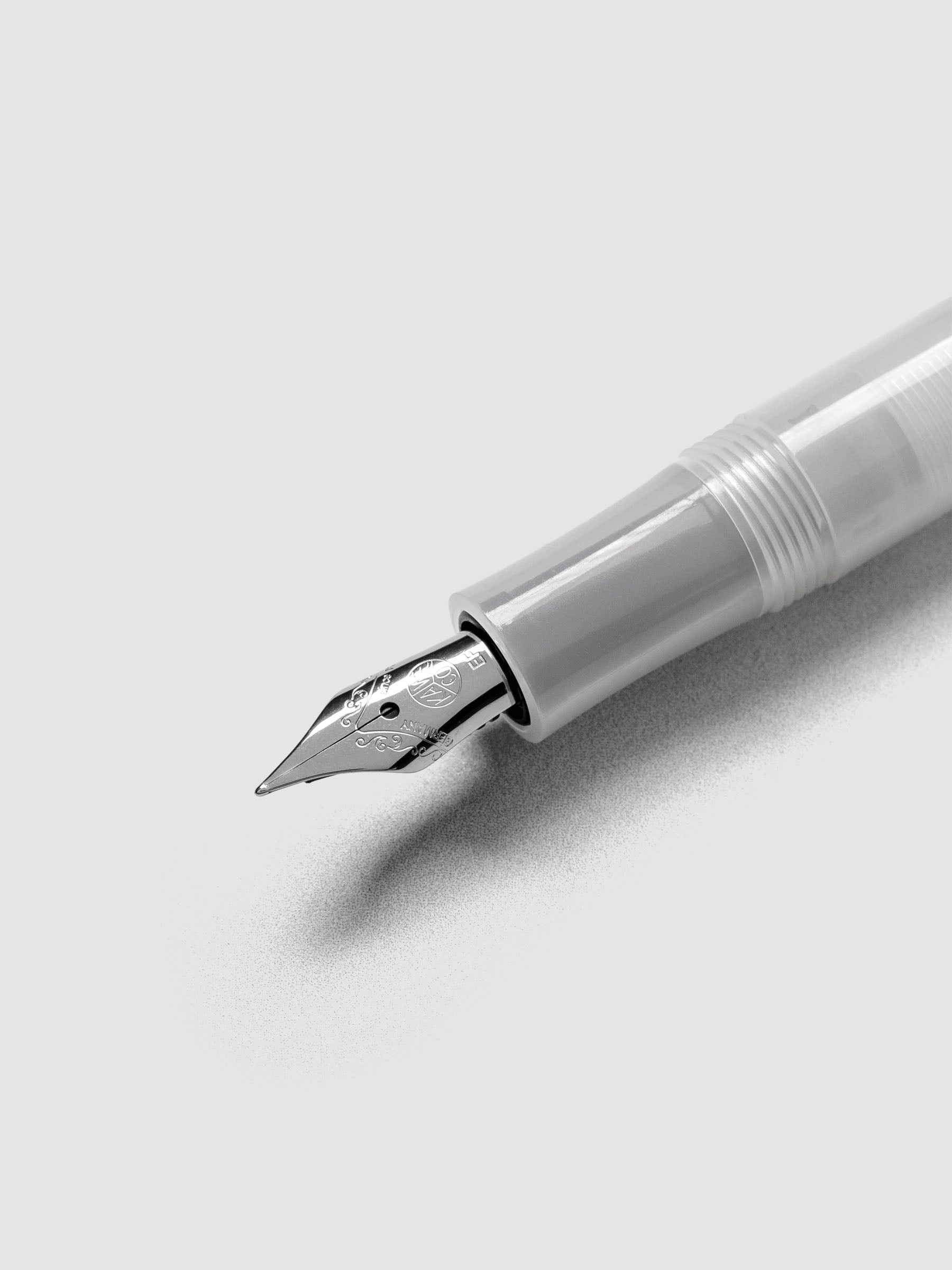 Silver nib on a clear fountain pen.