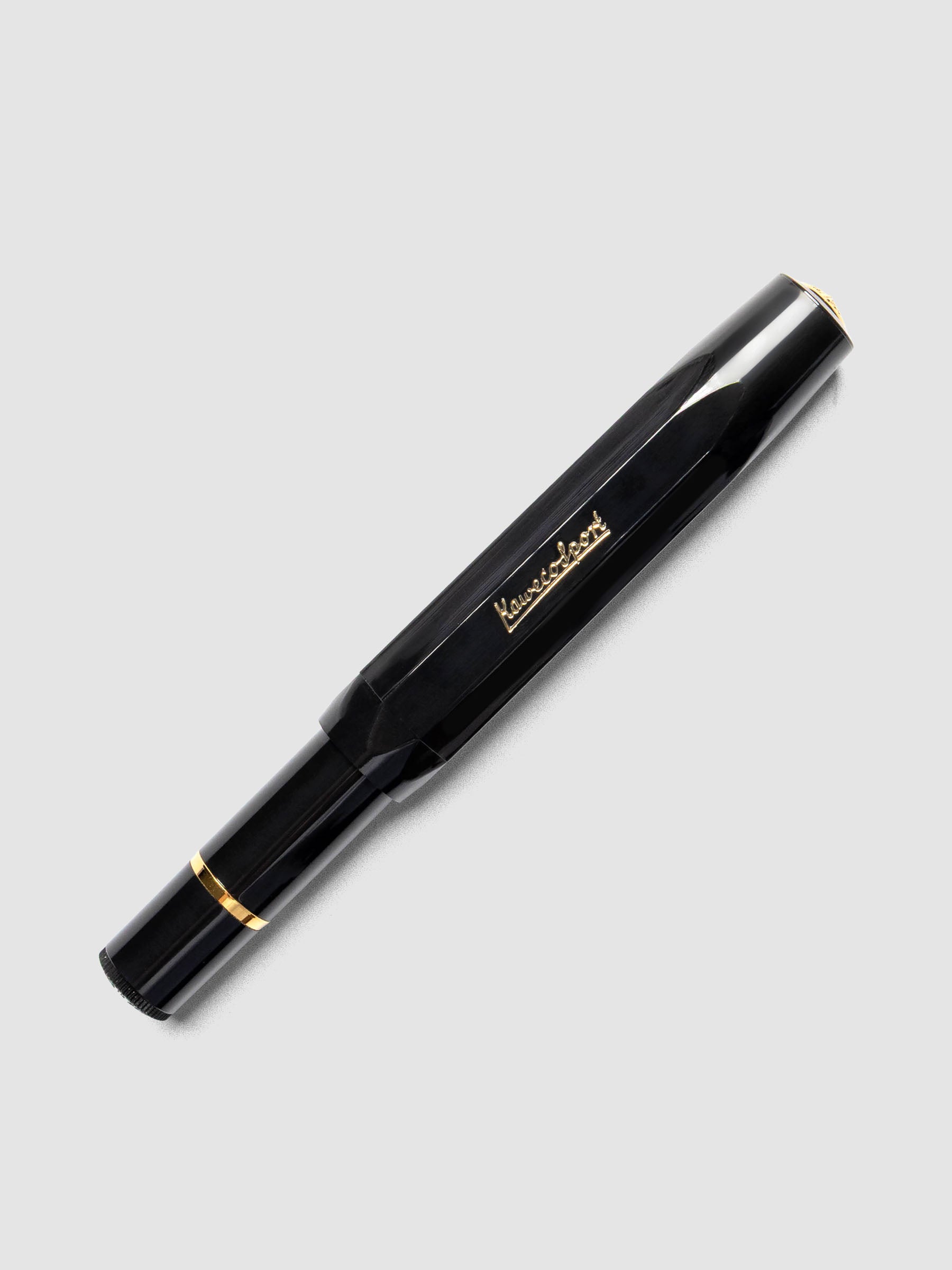 Black fountain pen with gold details shown capped.