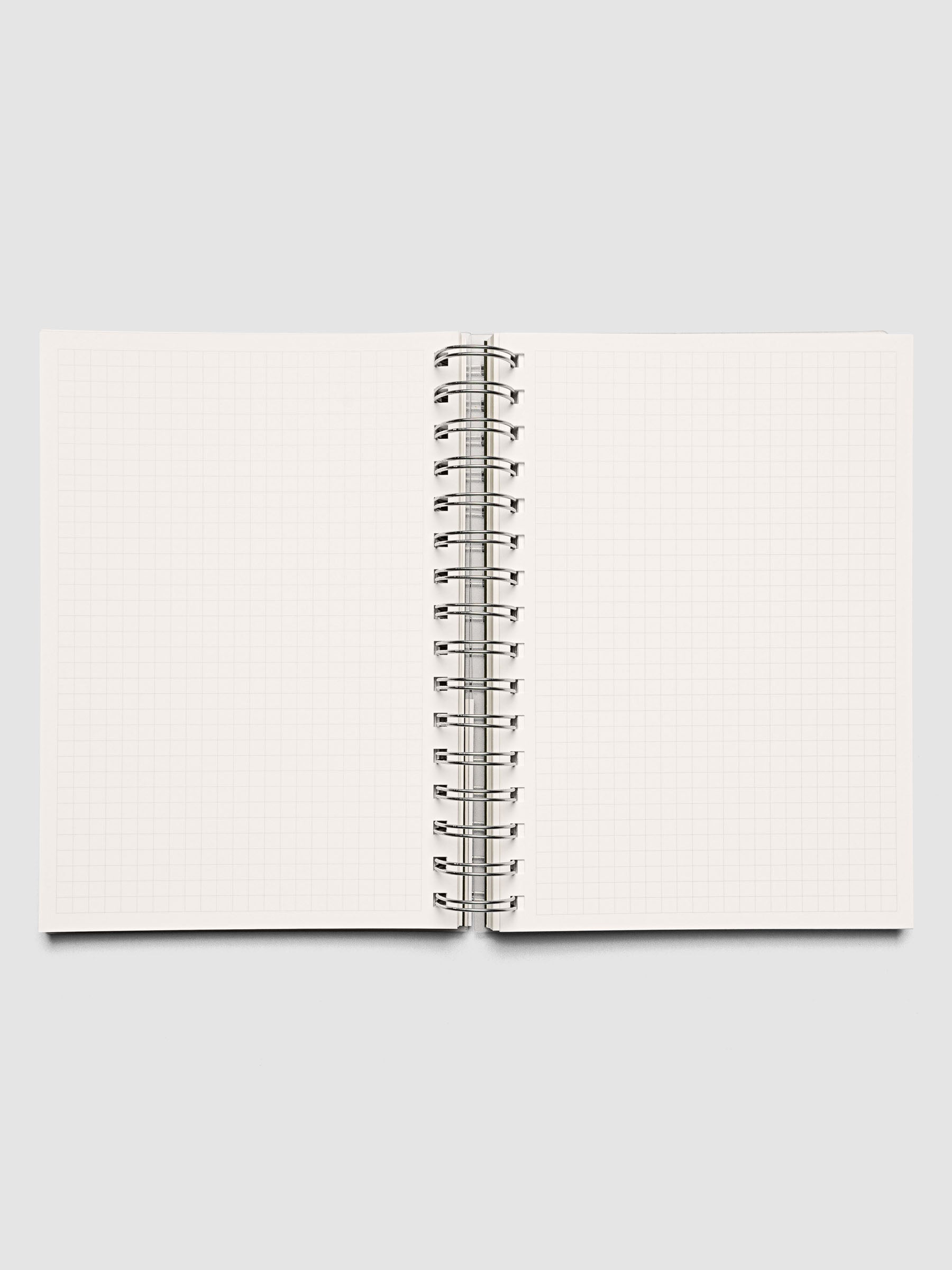Spiral Notebook in size A5 and color Olive green with graph note interior pages shown open.