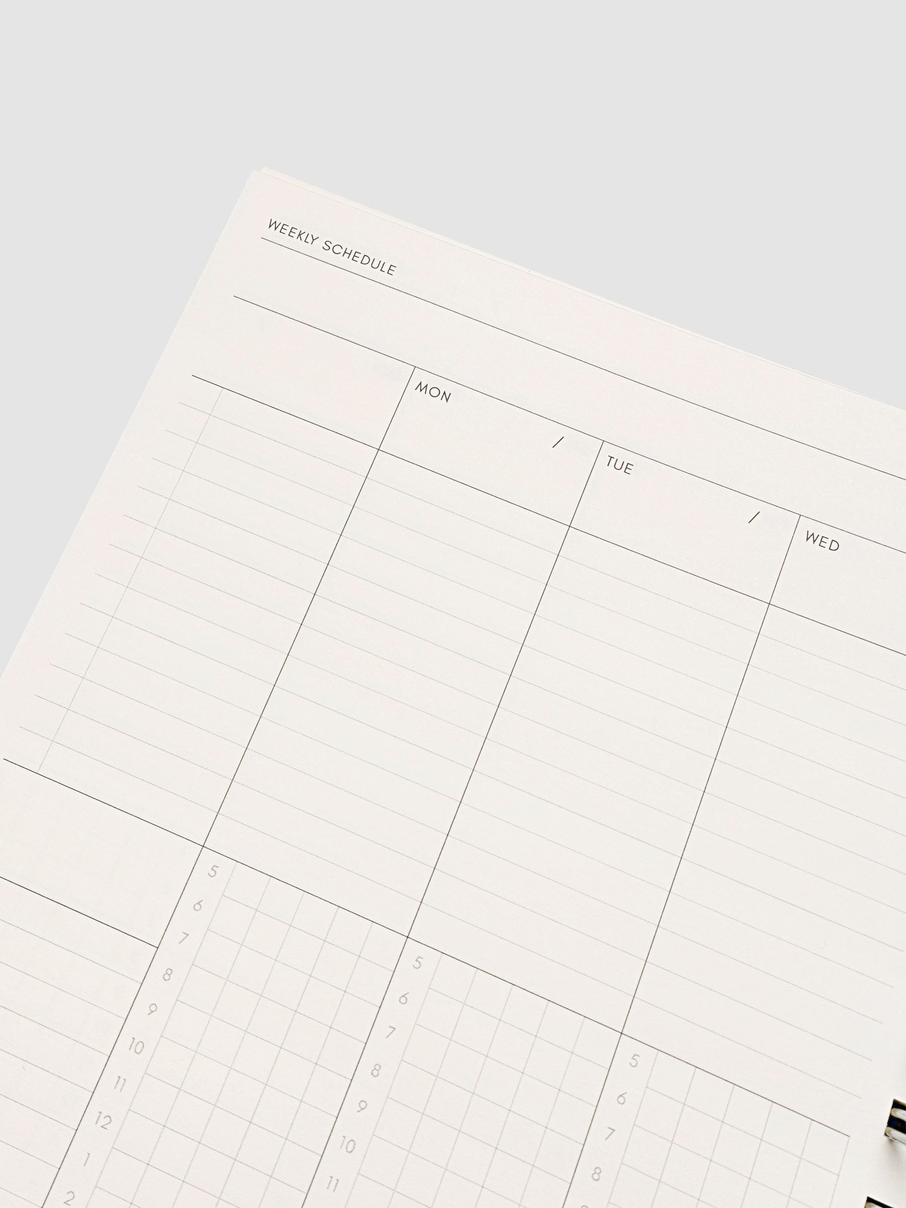 Spiral Notebook in size A5 and color Hyacinth blue shown open and close up displaying vertical weekly time block layout.