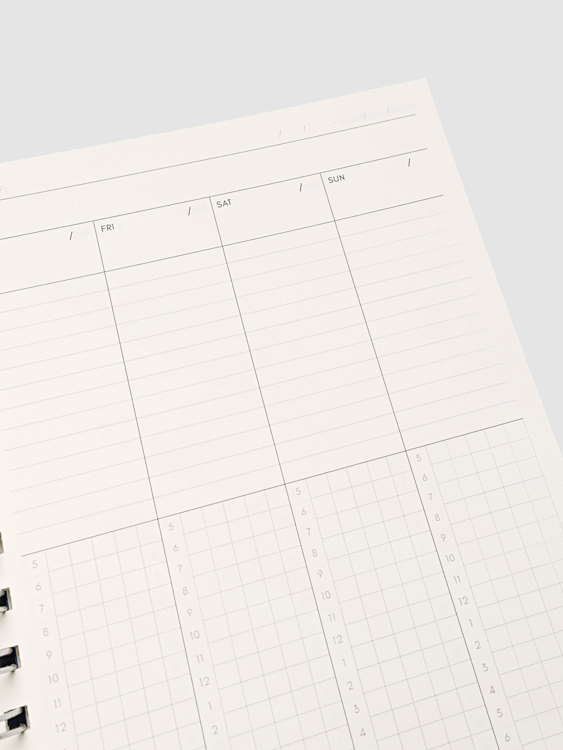 Spiral Notebook in size A5 and color Hyacinth blue shown open and close up displaying vertical weekly time block layout.