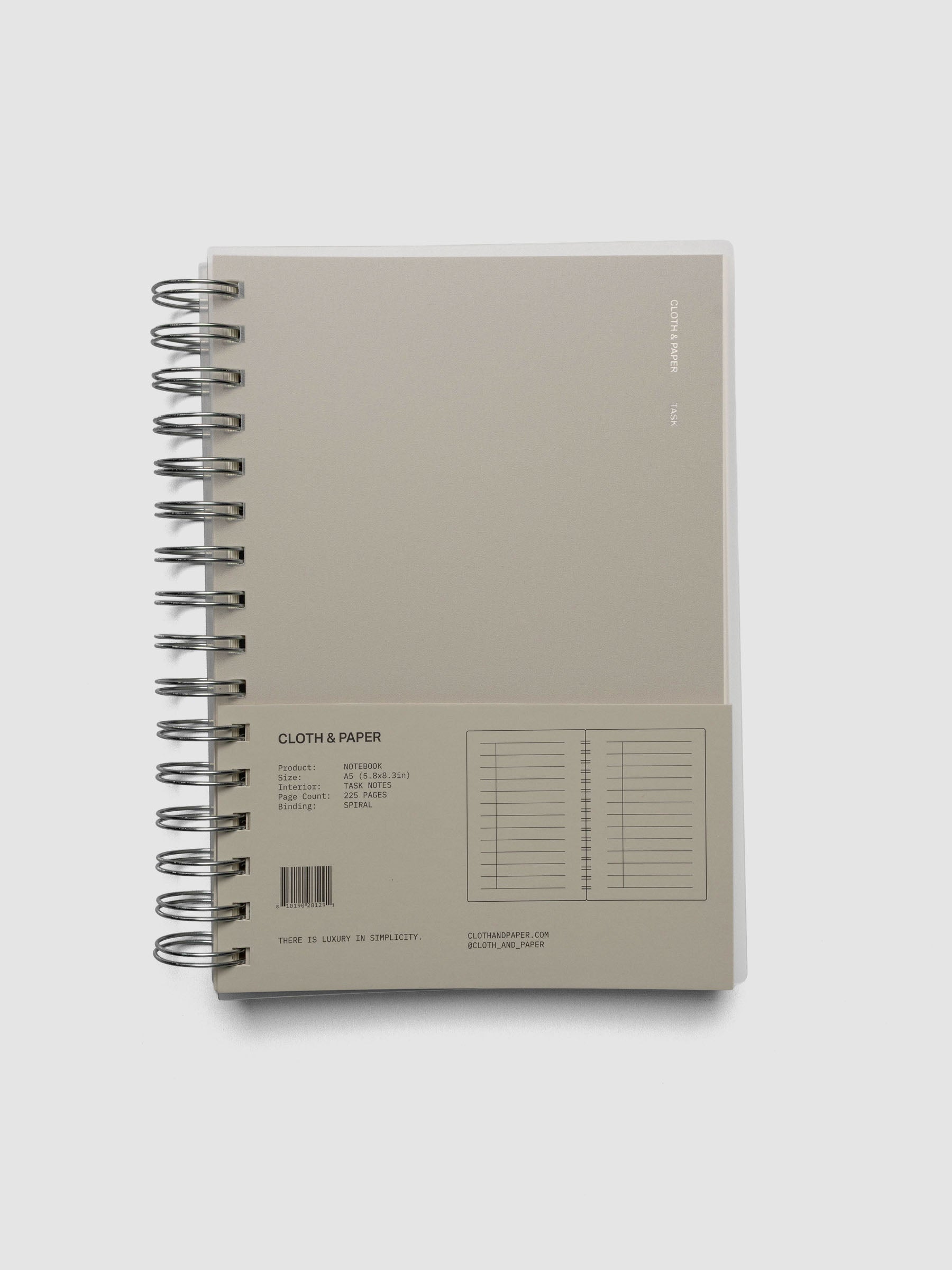 Spiral Notebook in size A5 and color Ristretto beige with Task interior pages shown closed with packaging.